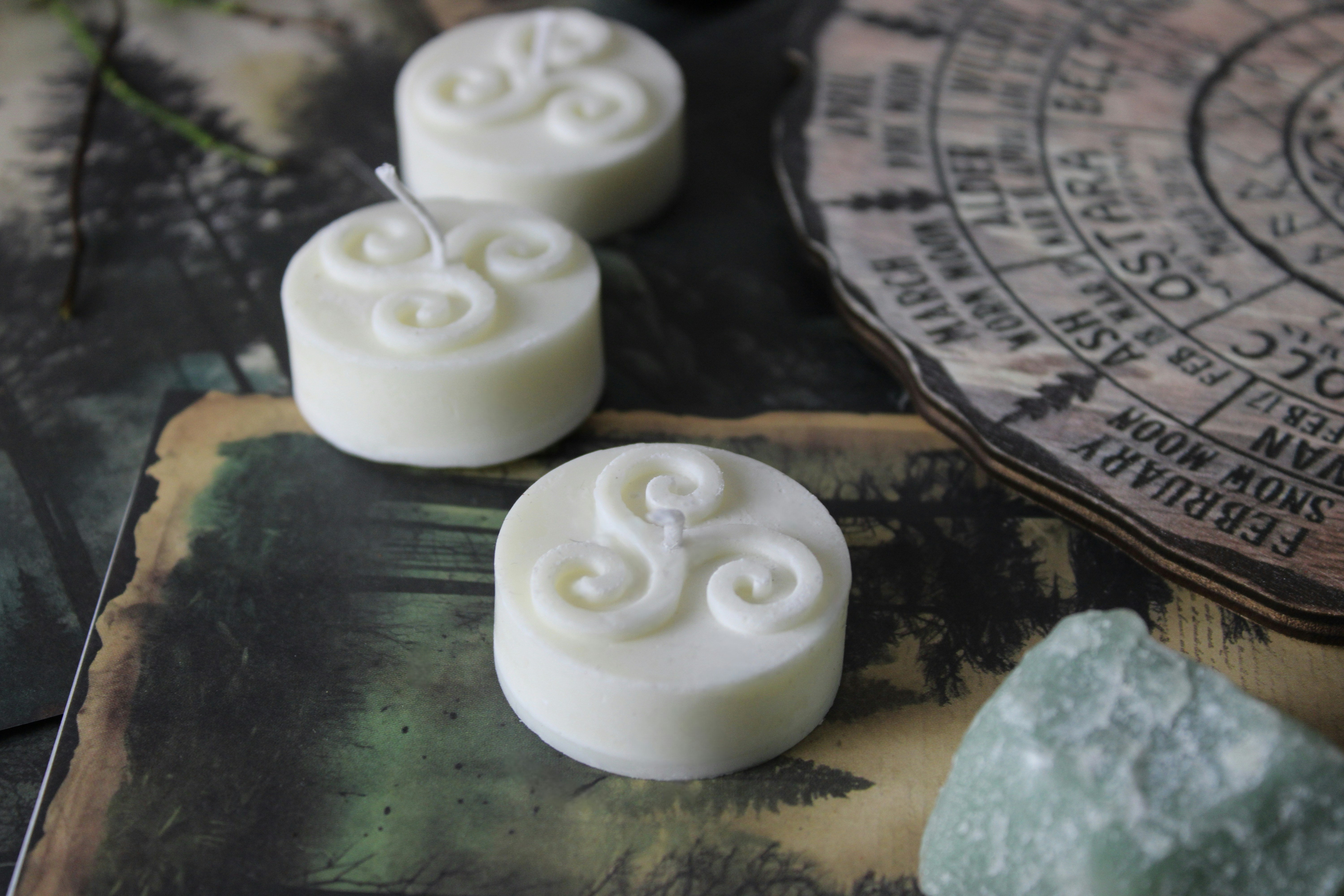 Three candles with a celtic knot design.