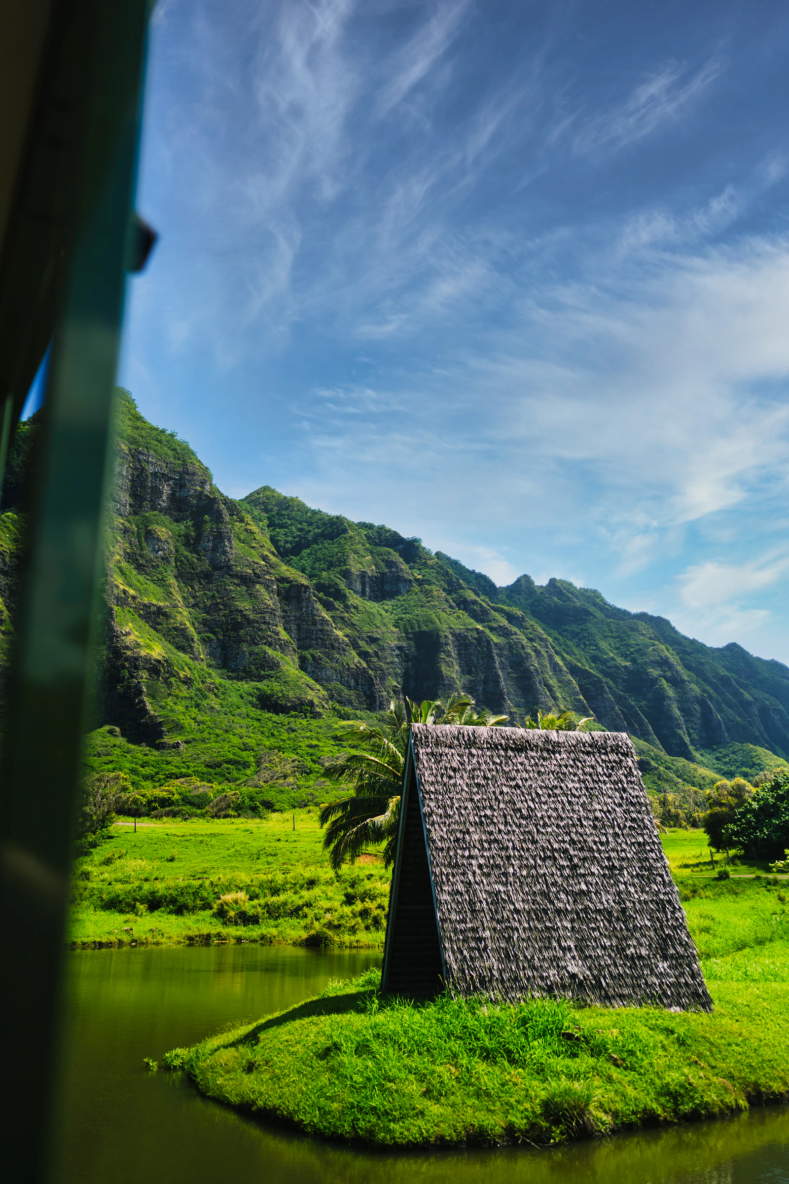 The iconic, lush green corrugated mountains of Kualoa Ranch, one of Oahu's most unforgettable landscapes.