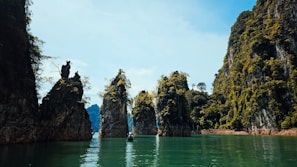 Rocky islands rise above emerald water.