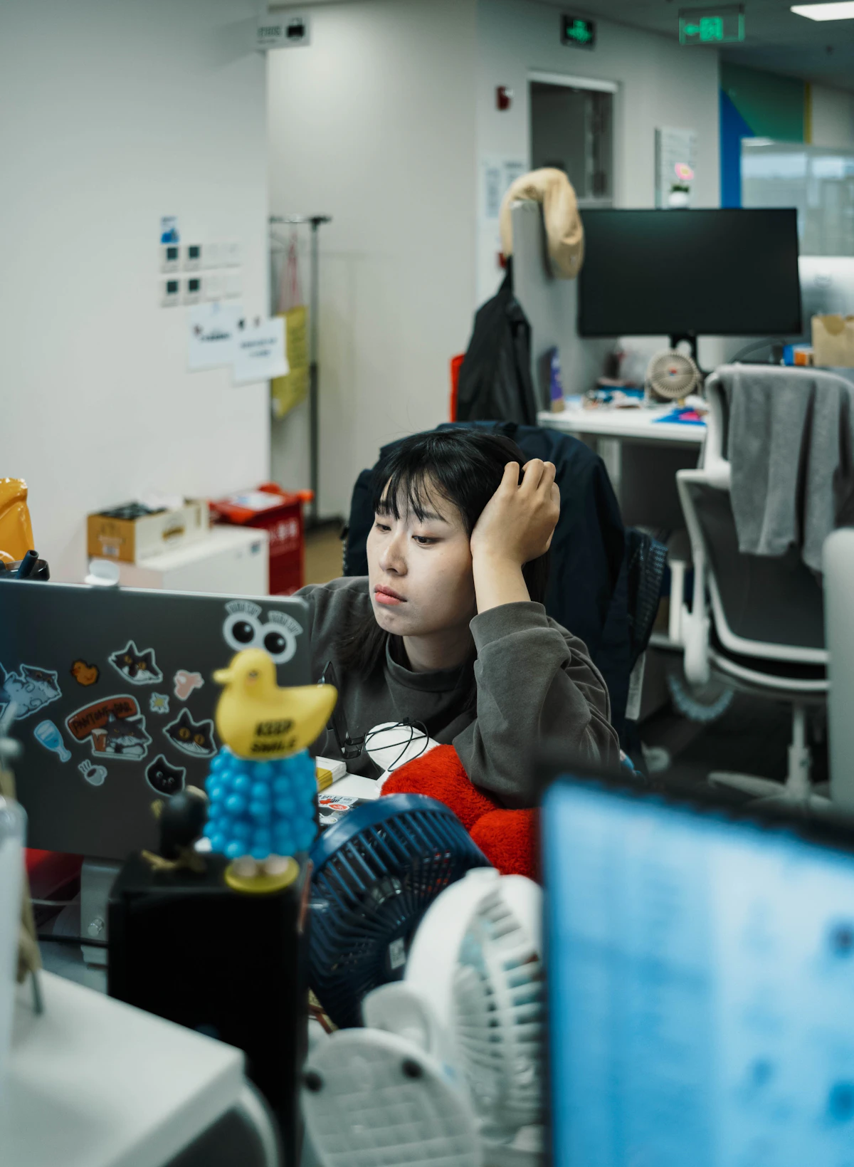 Woman looking tired while working at her desk