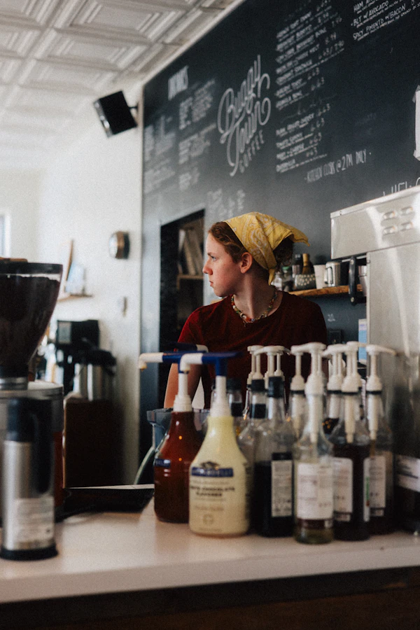 Cafe owner behind her coffee counter