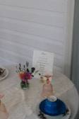 Elegant table setting with flowers and a menu.