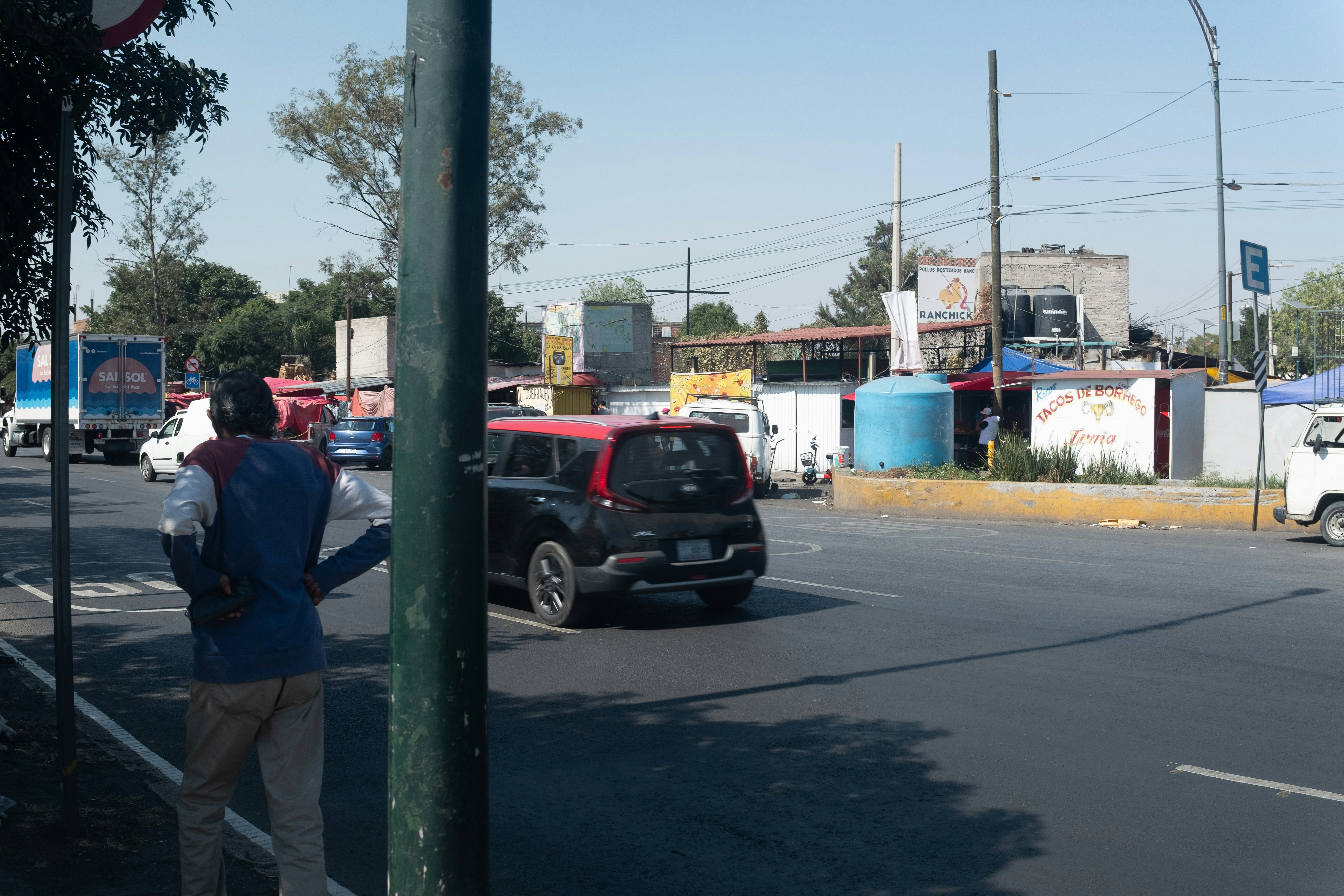 Cars and pedestrians on a busy city street.