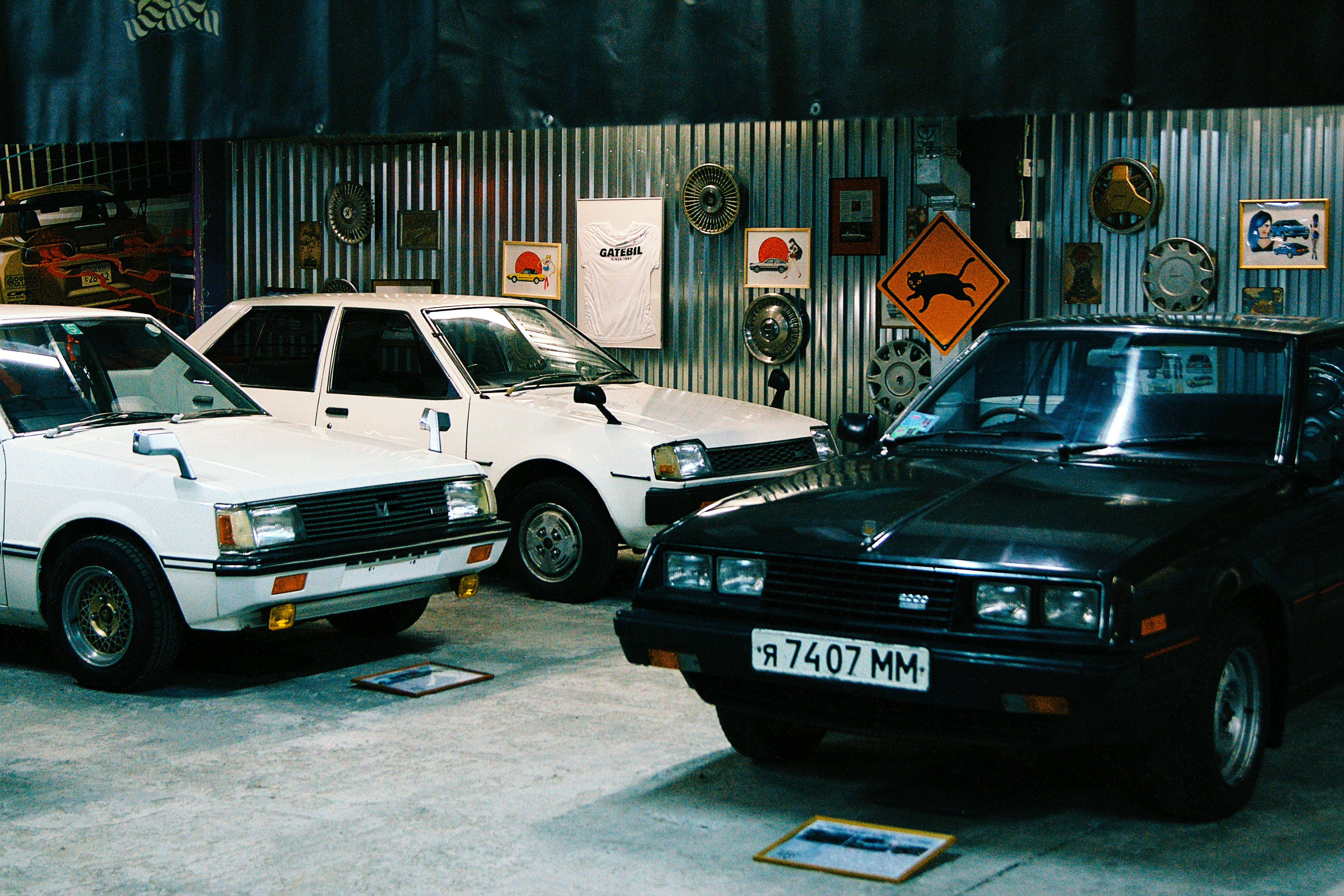 Classic cars are displayed in a vintage garage.