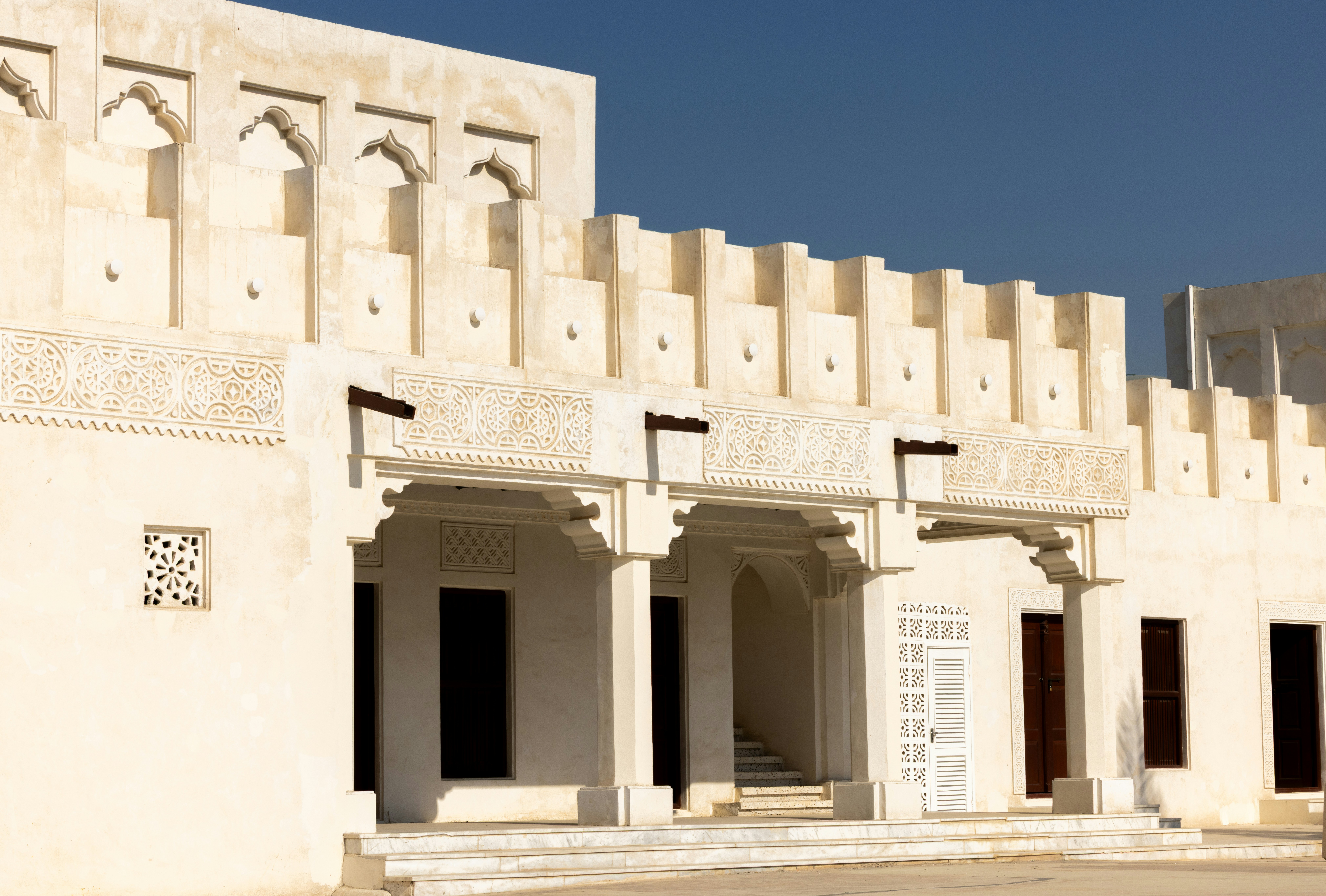 Arabic architecture showcases ornate designs and white walls.