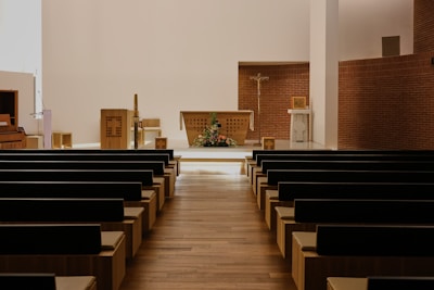 Inside of a church with rows of pews.