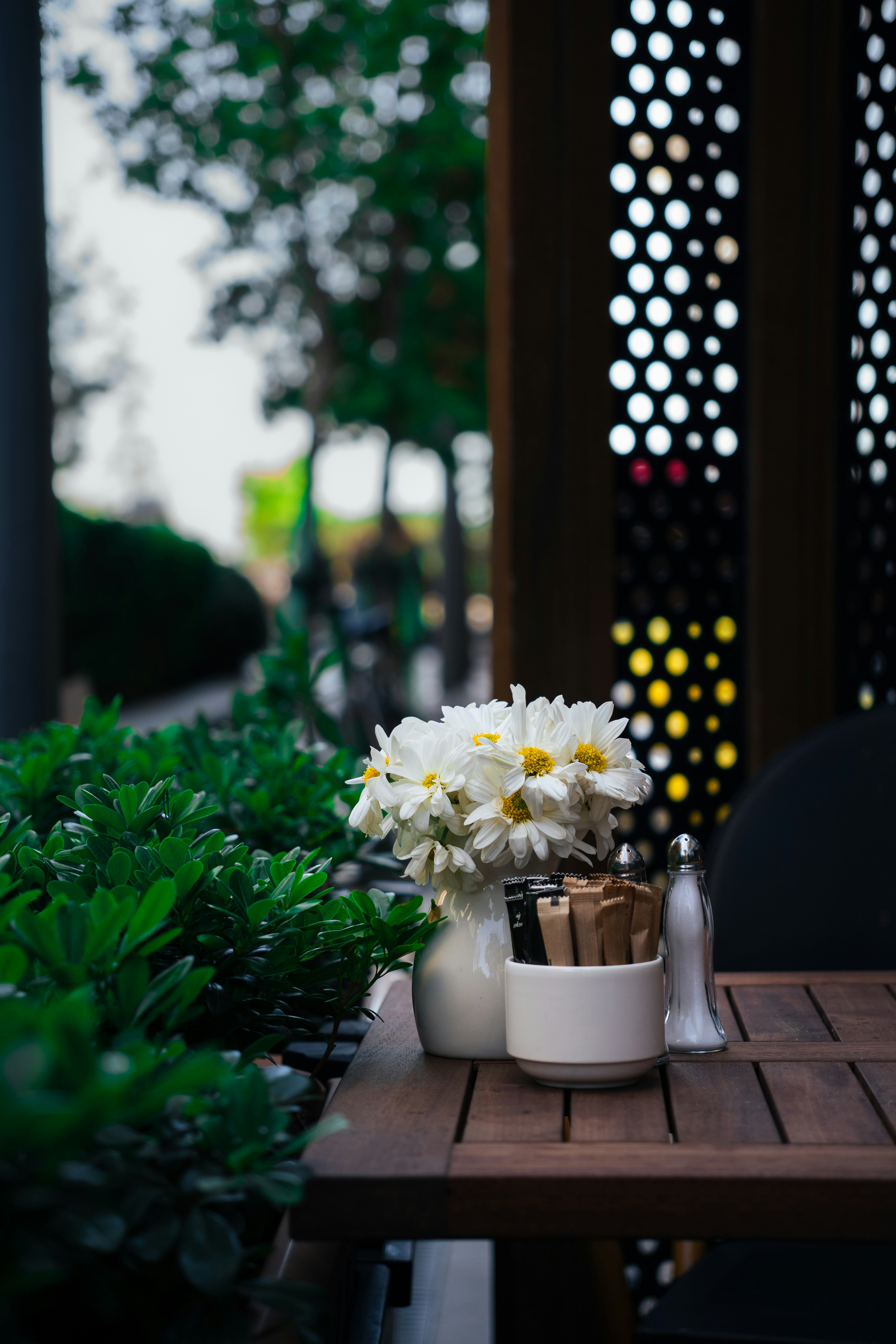 A table is set with flowers and condiments.