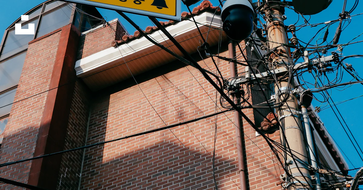 Power lines and cctv cameras against a blue sky. photo – Free Cable ...