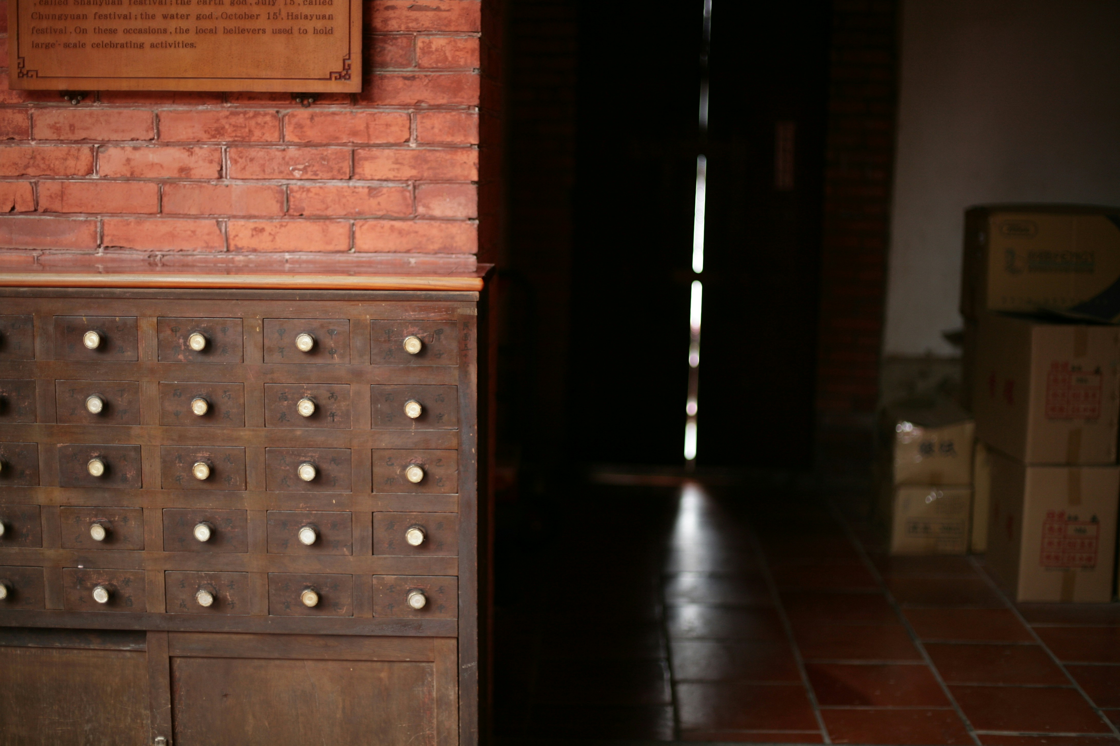 Old wooden drawers with a dark doorway.