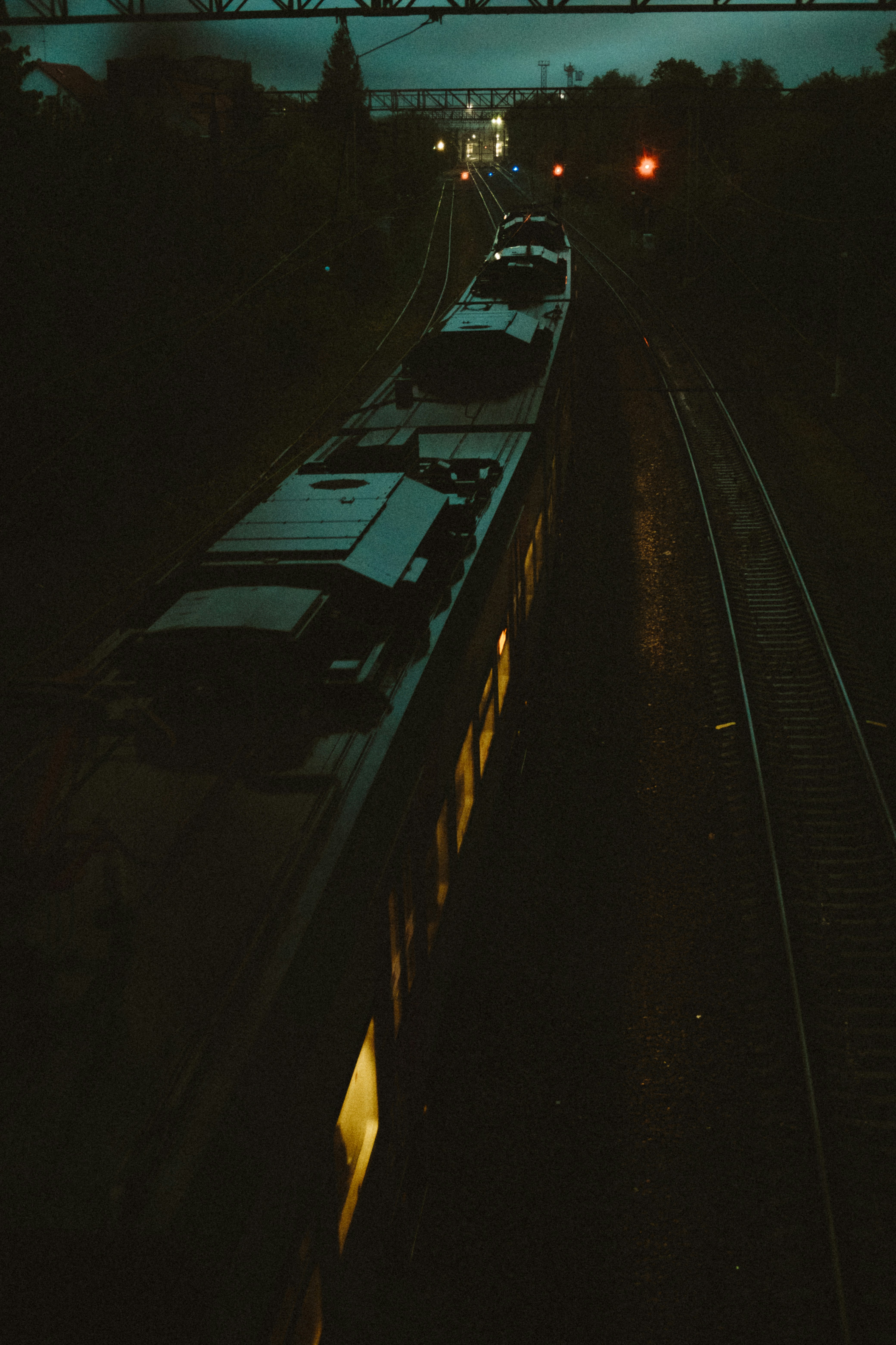 A glowing silver midnight train on an empty hidden platform, mist swirling around, warm amber lights inside, mysterious travel vibe, cinematic and magical atmosphere