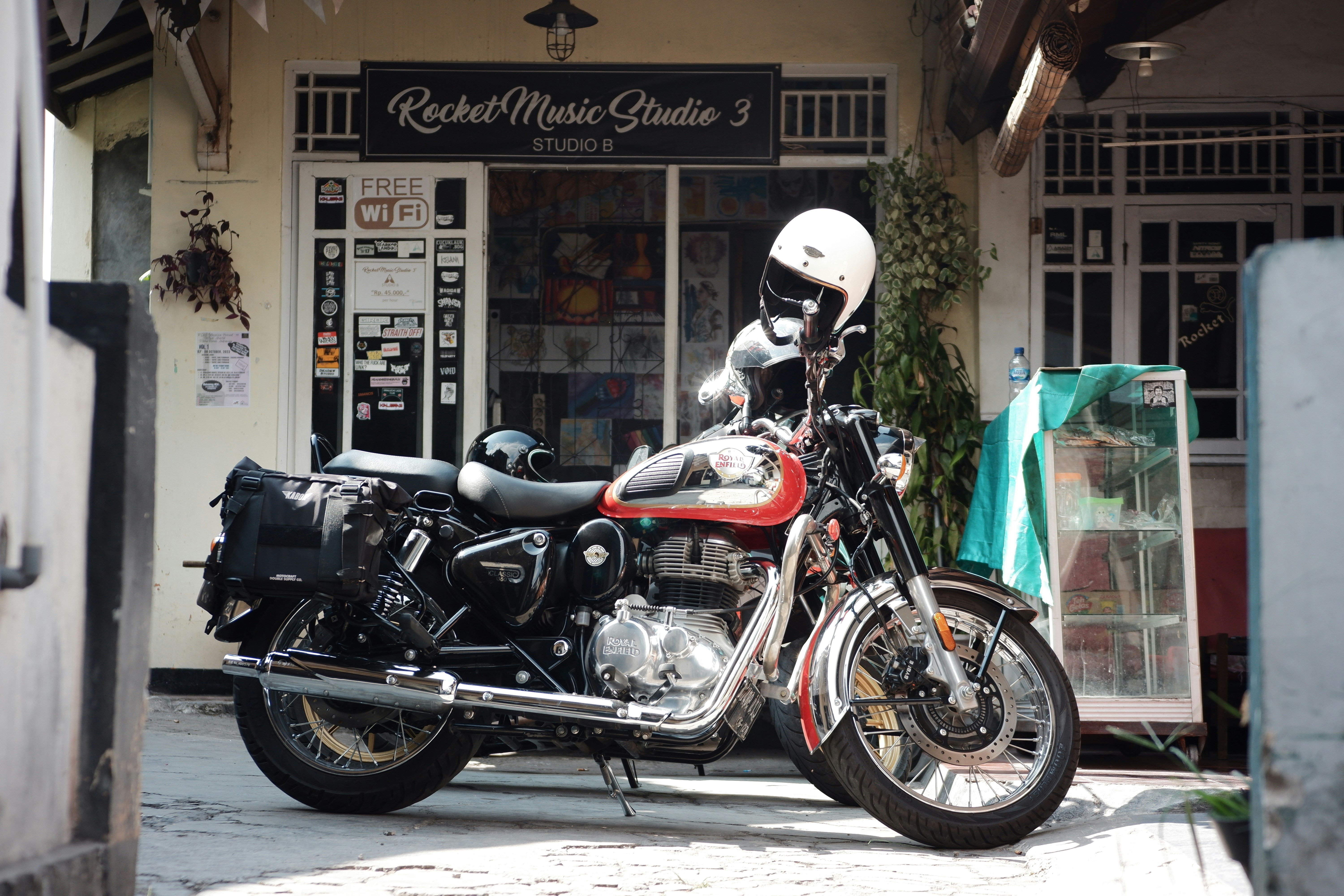 Motorcycle parked in front of a music studio.