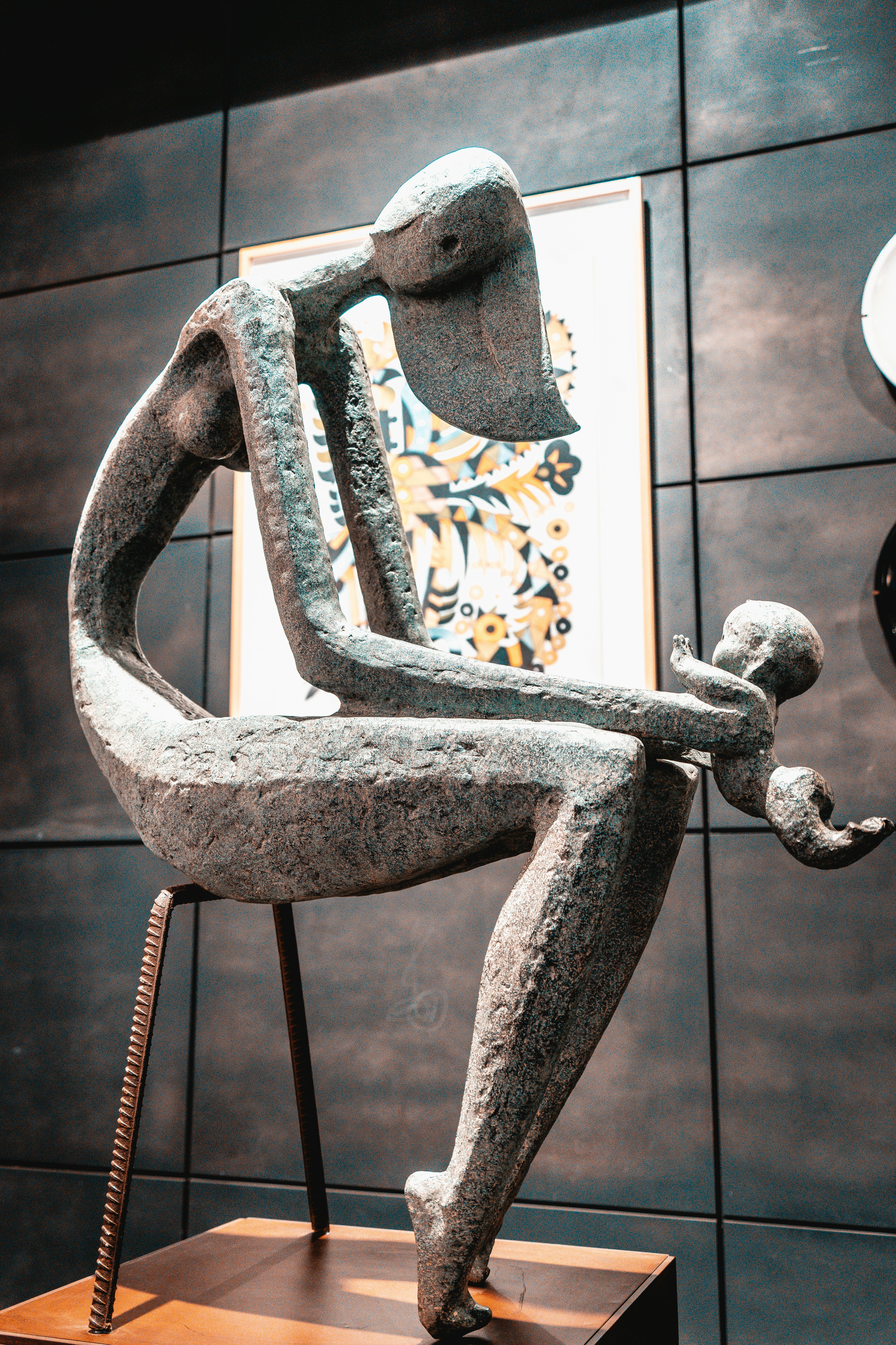 A sculpture shows a mother holding her baby.