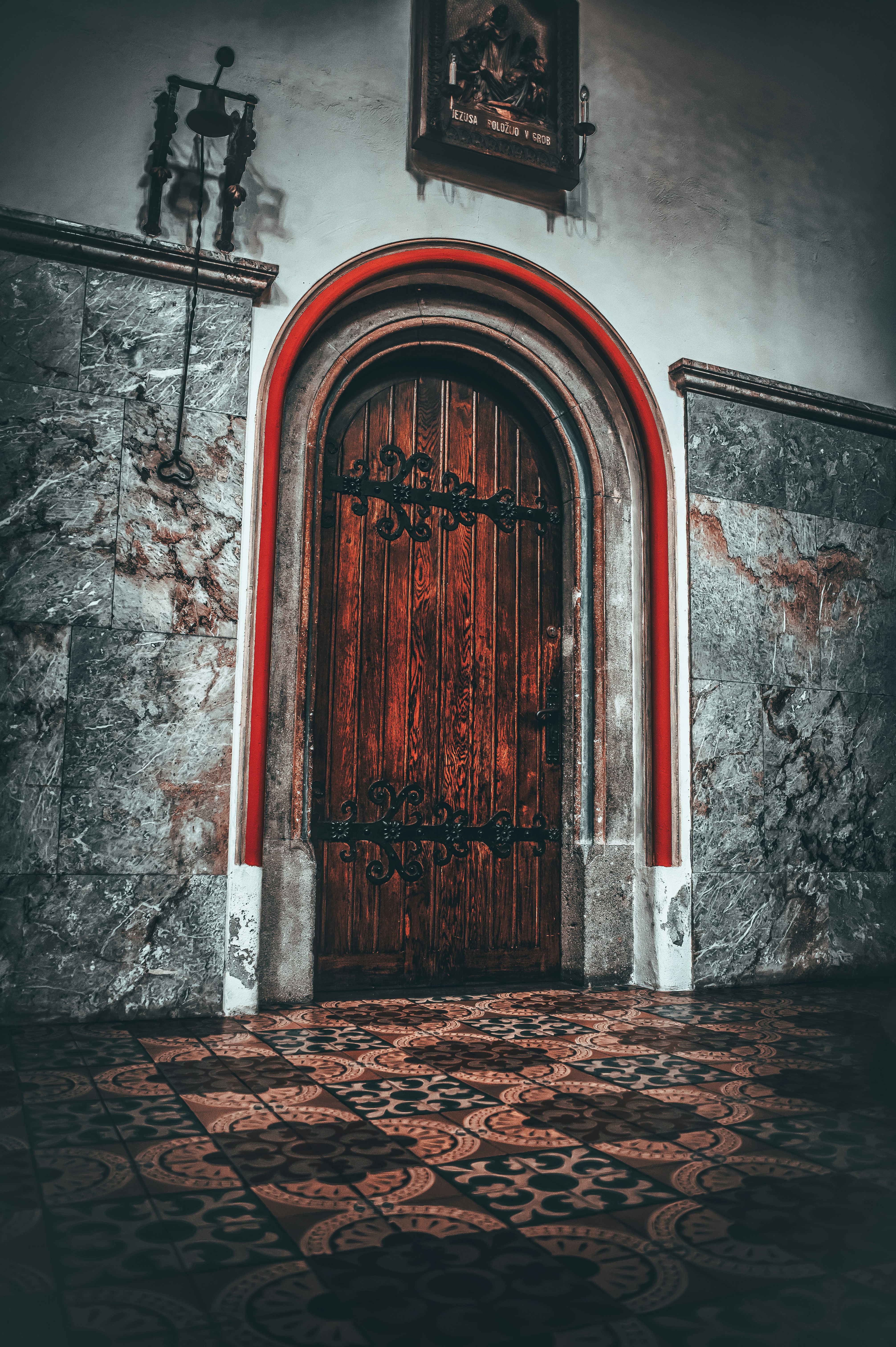 An ornate wooden door in a stone wall.
