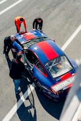 Mechanics inspect the race car before a race NASA Member Benefits Motorsports Gear