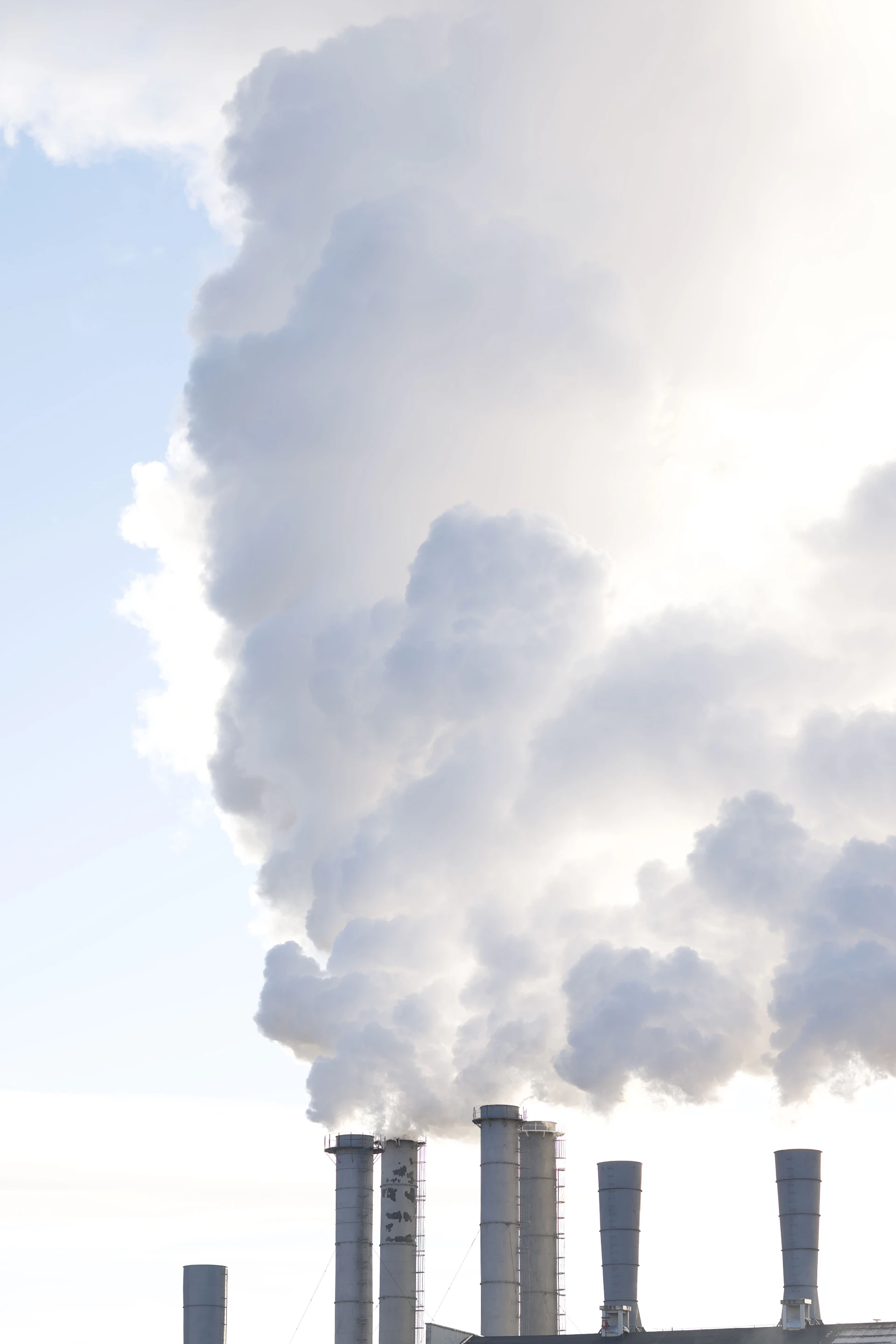 Chimneys are emitting large plumes of smoke