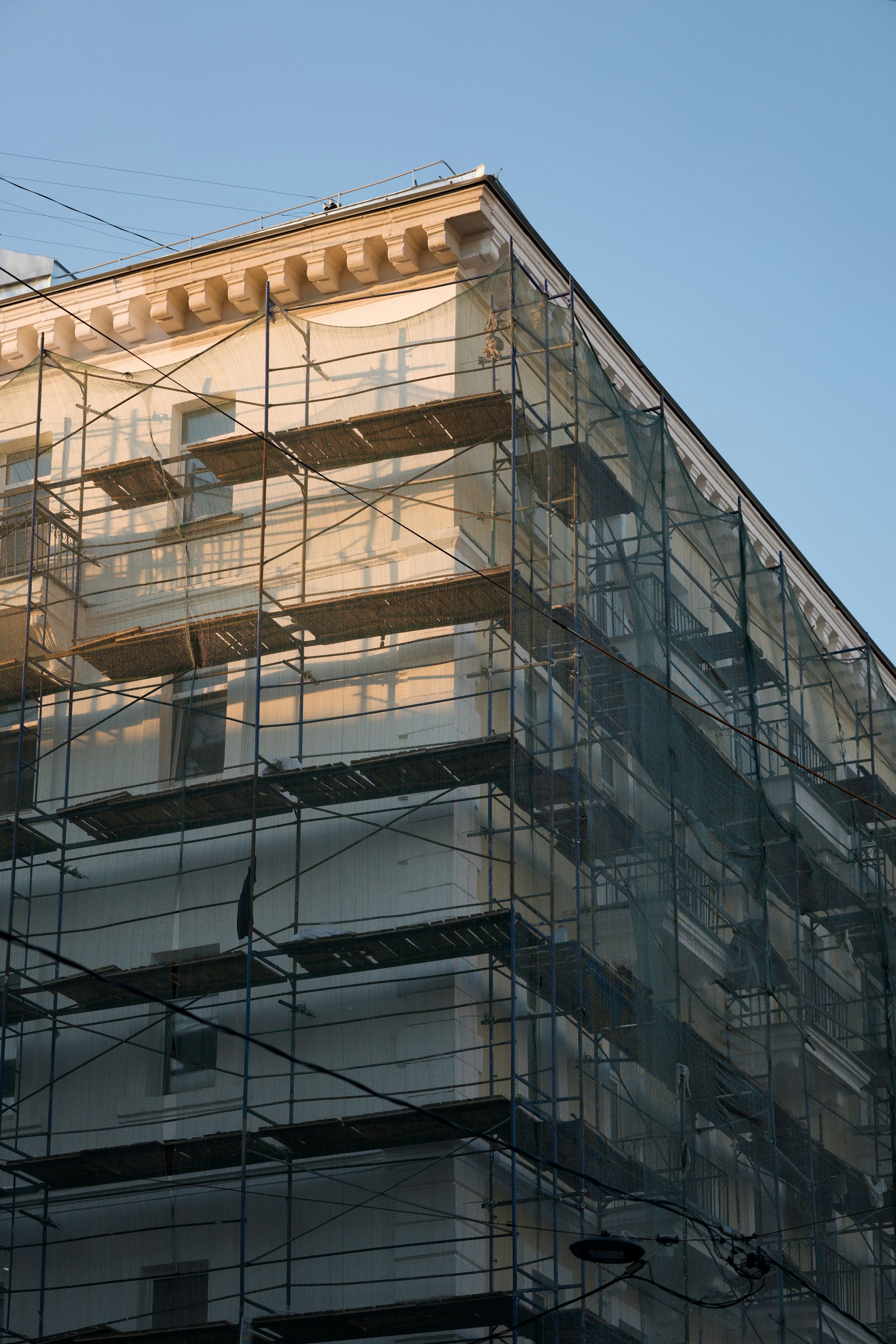 Building undergoing repairs, covered in scaffolding.