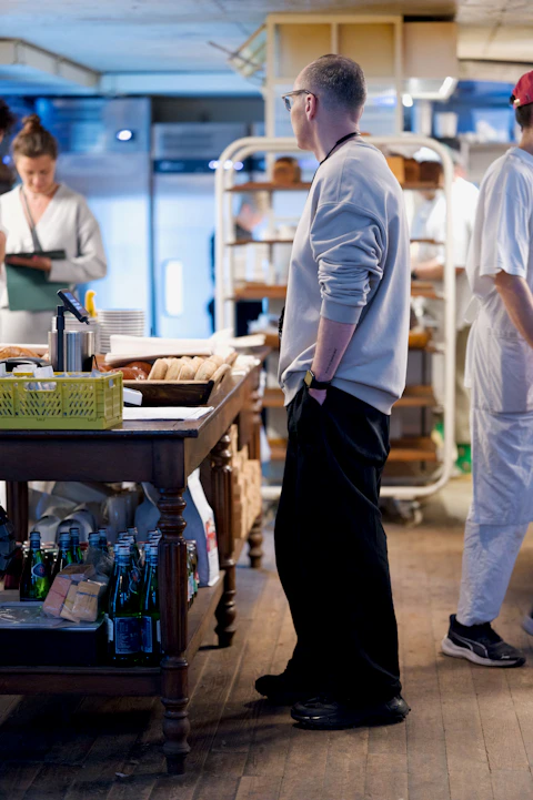 Restaurant manager overseeing operations before service