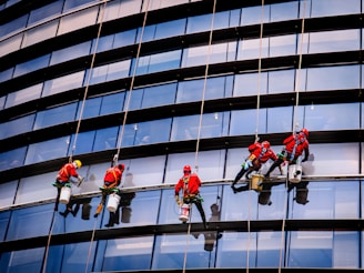Window washers are cleaning the exterior of a tall building.