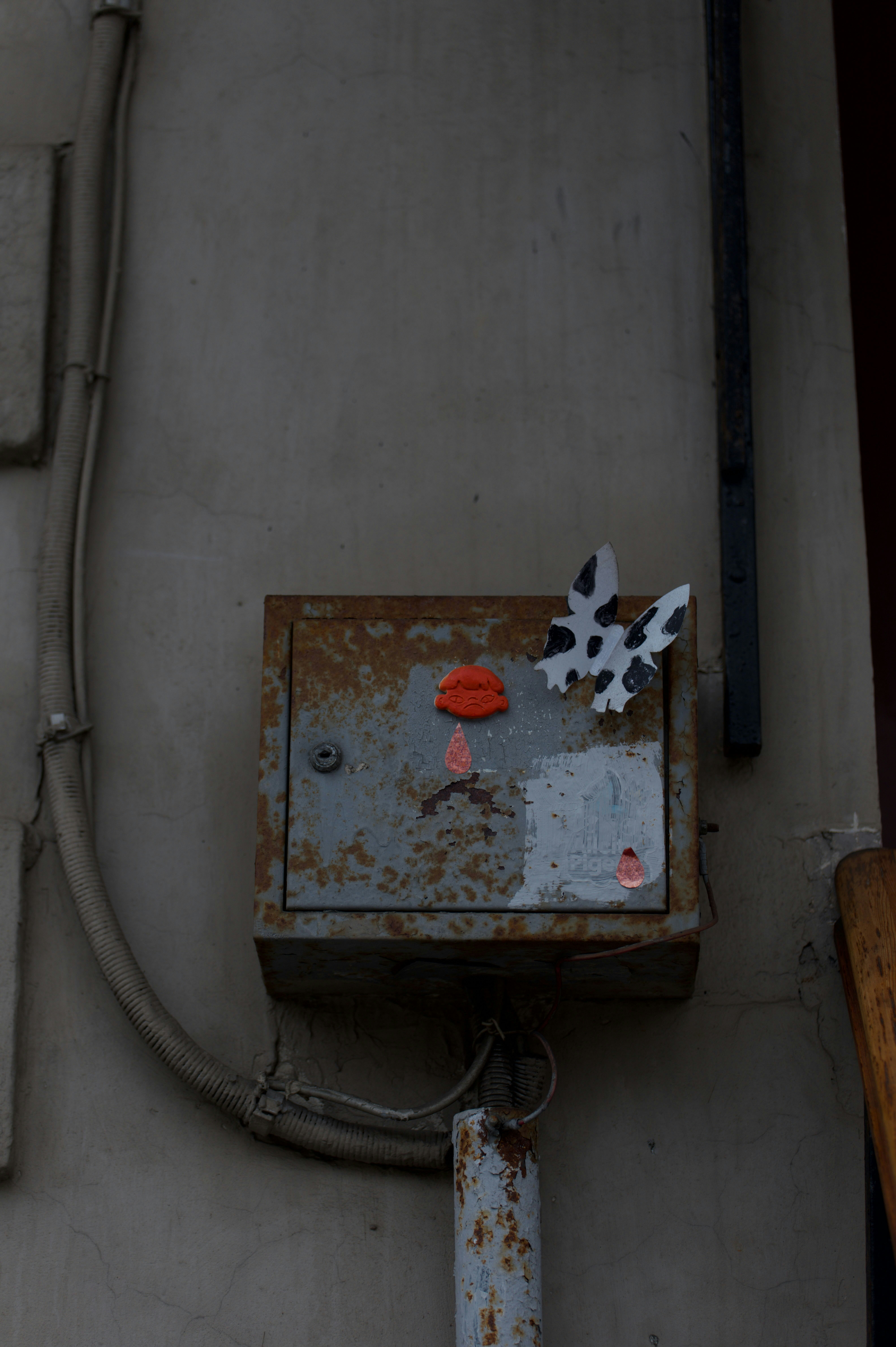 A rusty box decorated with art