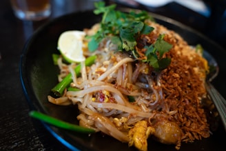 Delicious pad thai with fresh herbs and lime.