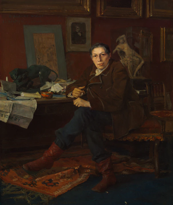 A person sits at a desk in a room.