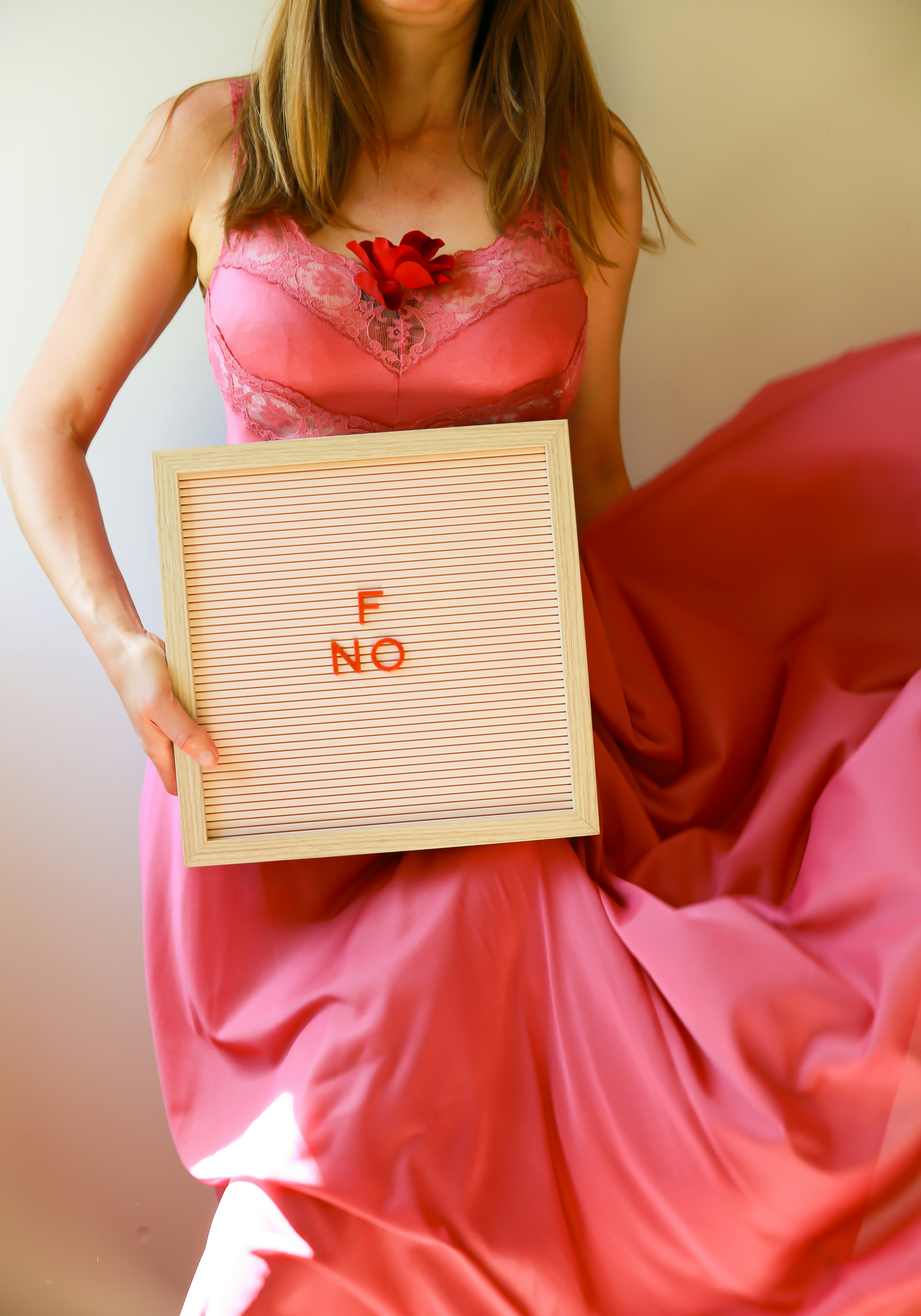 Woman holds a sign saying "no".