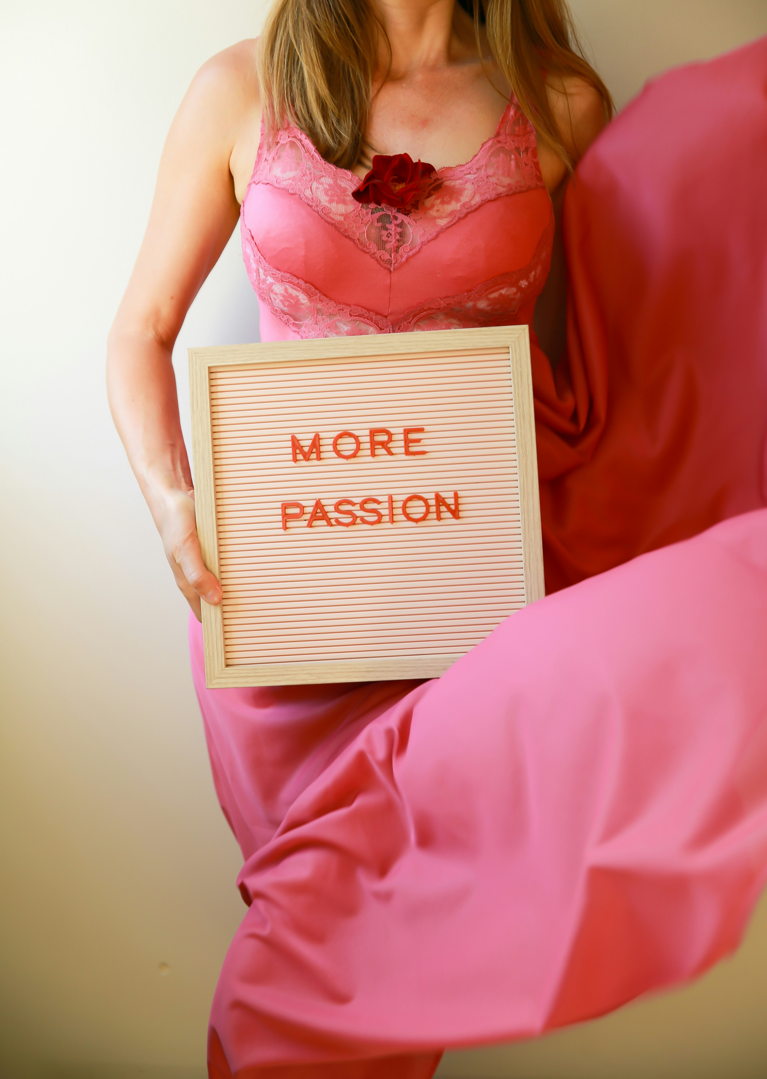 Woman holds a sign that says "more passion."