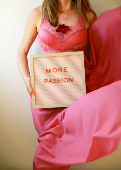 Woman holds a sign that says "more passion."