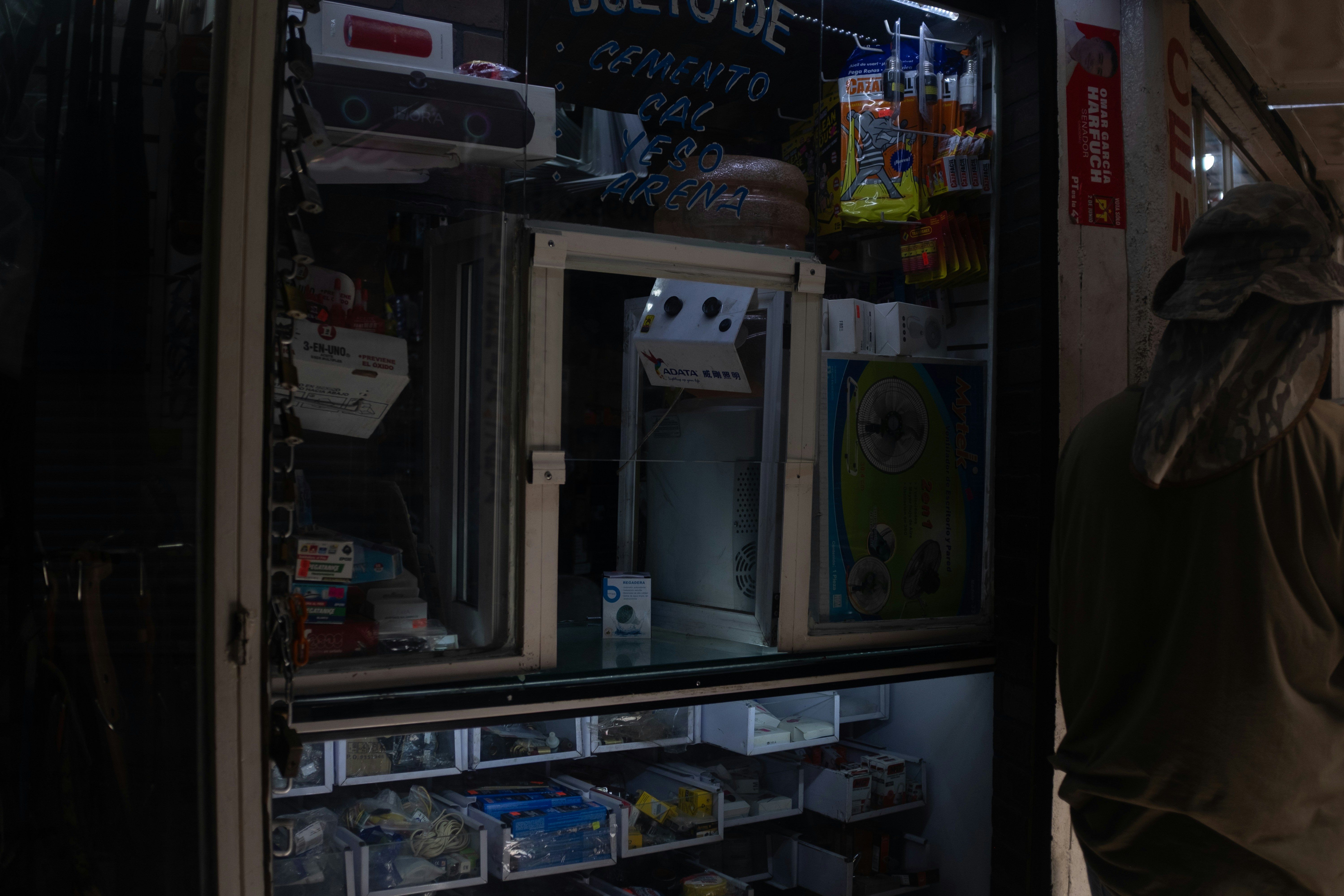 A street shop, open at night.