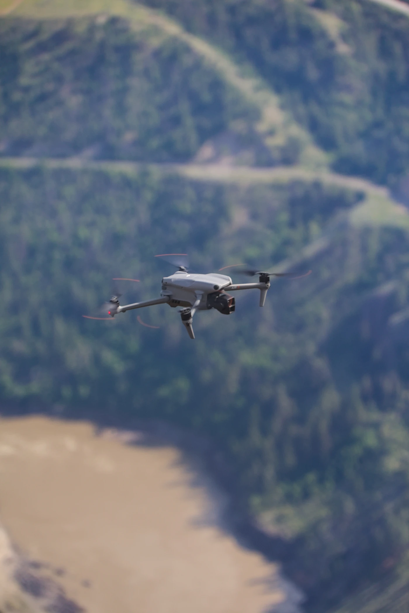 Drone flying over a river and mountain landscape