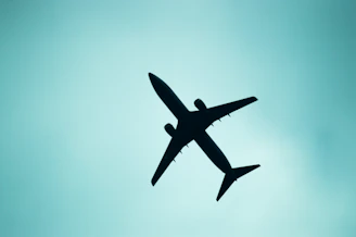A silhouette of an airplane in the sky.