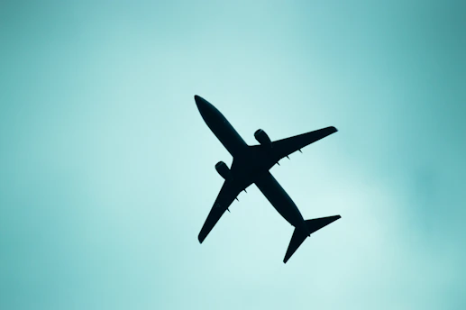 A silhouette of an airplane in the sky.