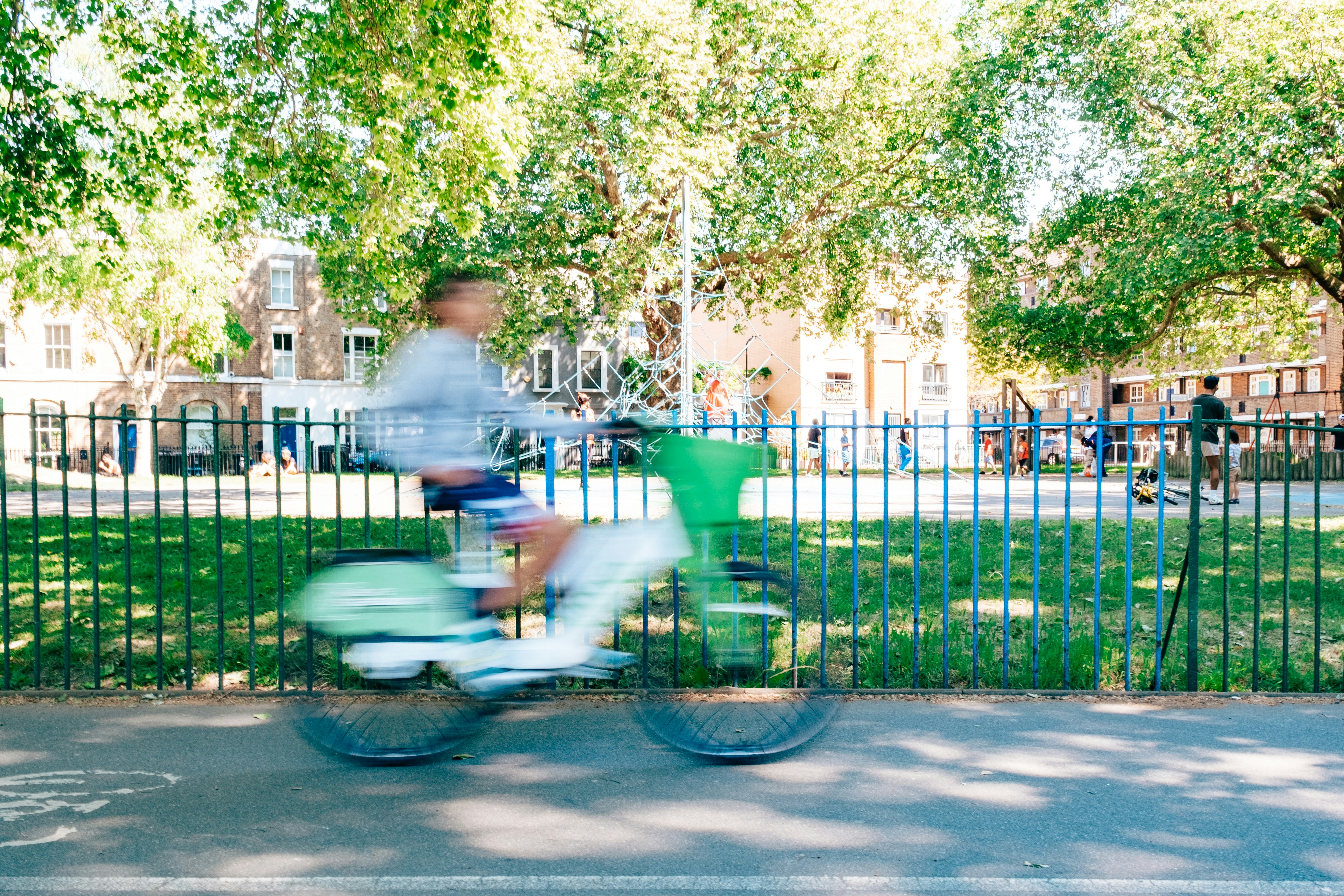 A cyclist rides a bicycle in a blurry motion.