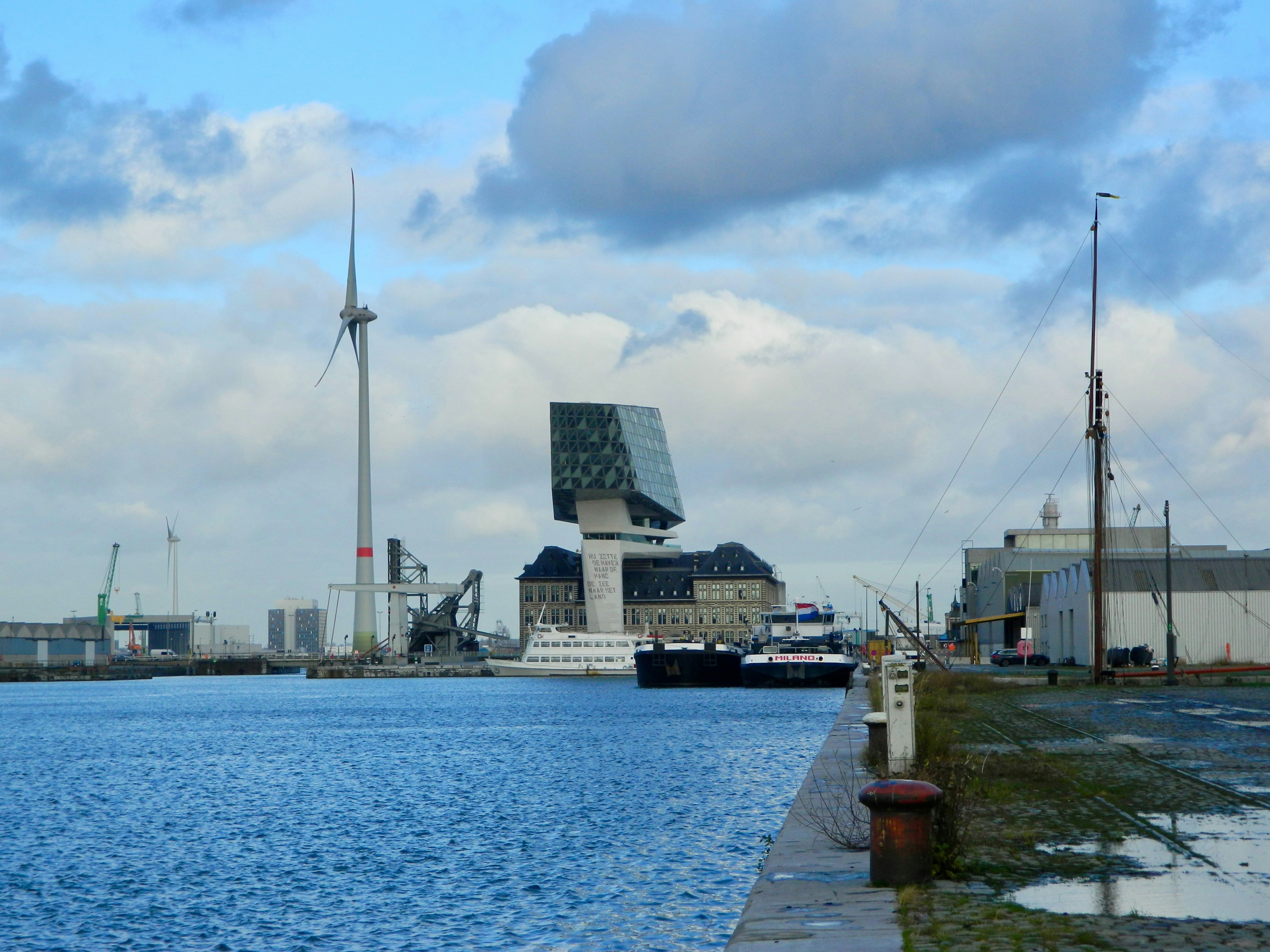 A modern building rests beside the water.