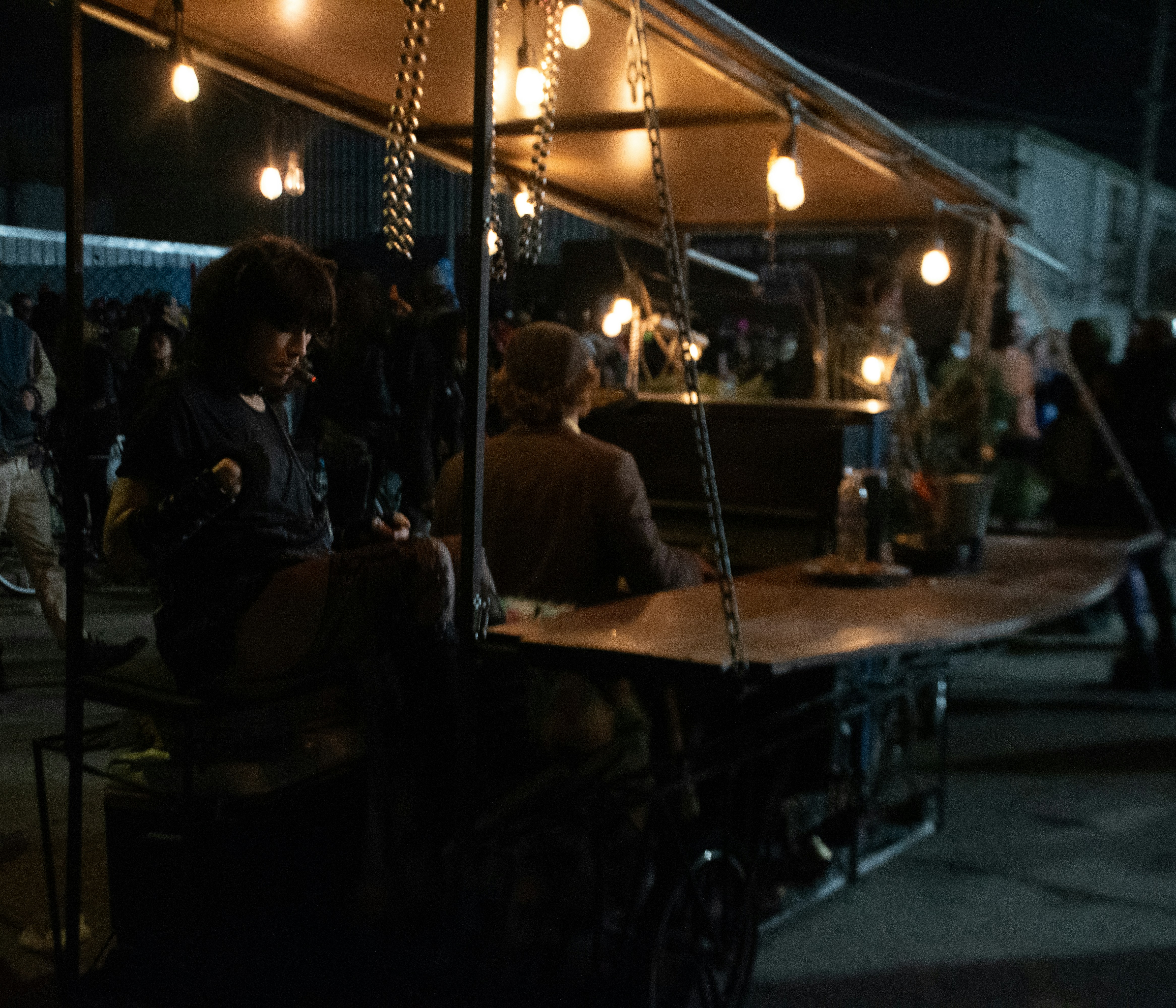 A food cart operates under the glow of lights.
