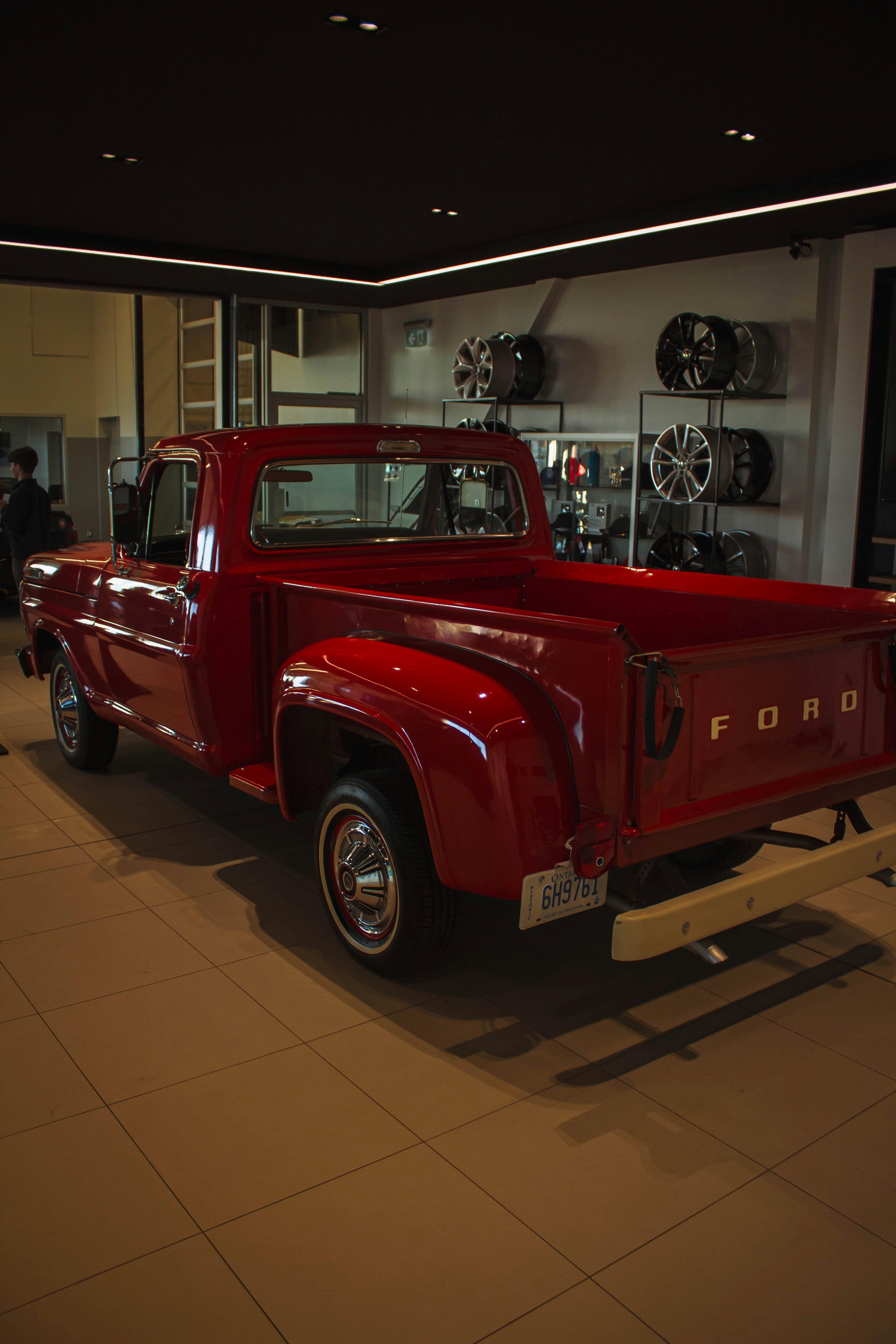 Un camion Ford rouge brillant à l’intérieur d’un concessionnaire.