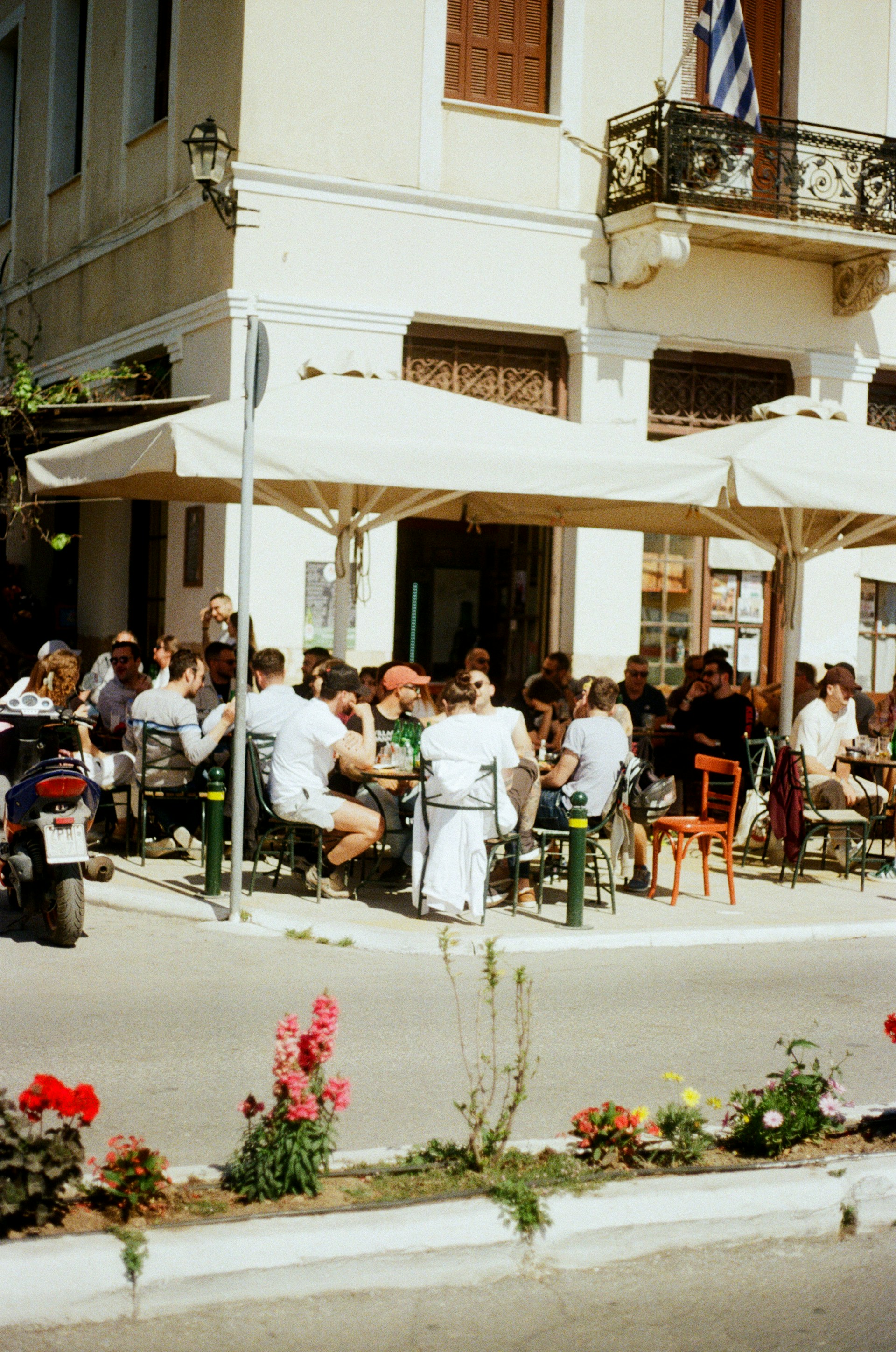 People are relaxing at a cafe outdoors.