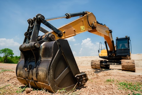 Here's a caption for the image: an excavator is ready for work on a construction site.