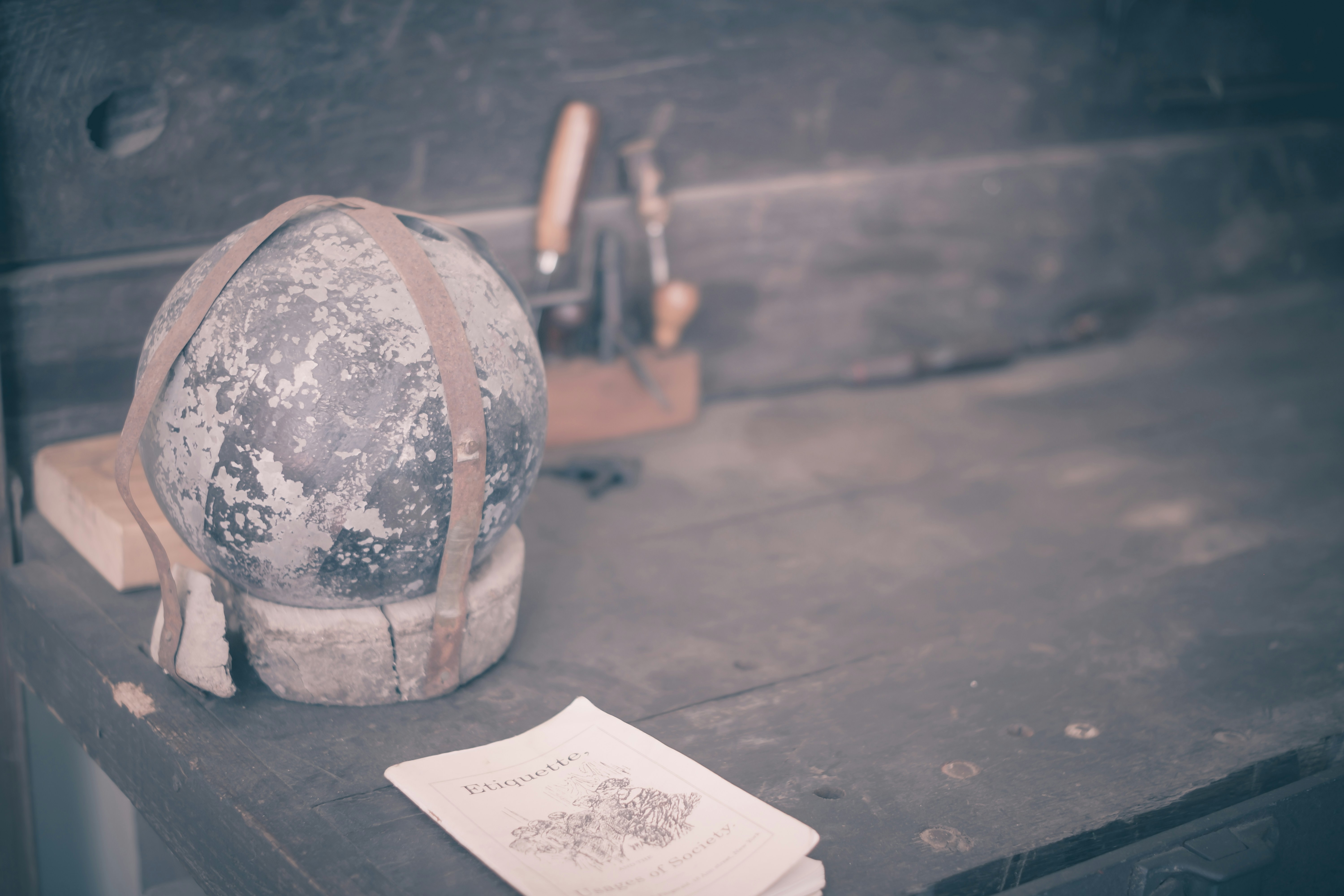 Old tools and a weathered work surface. (Photo by Magic Fan on Unsplash)