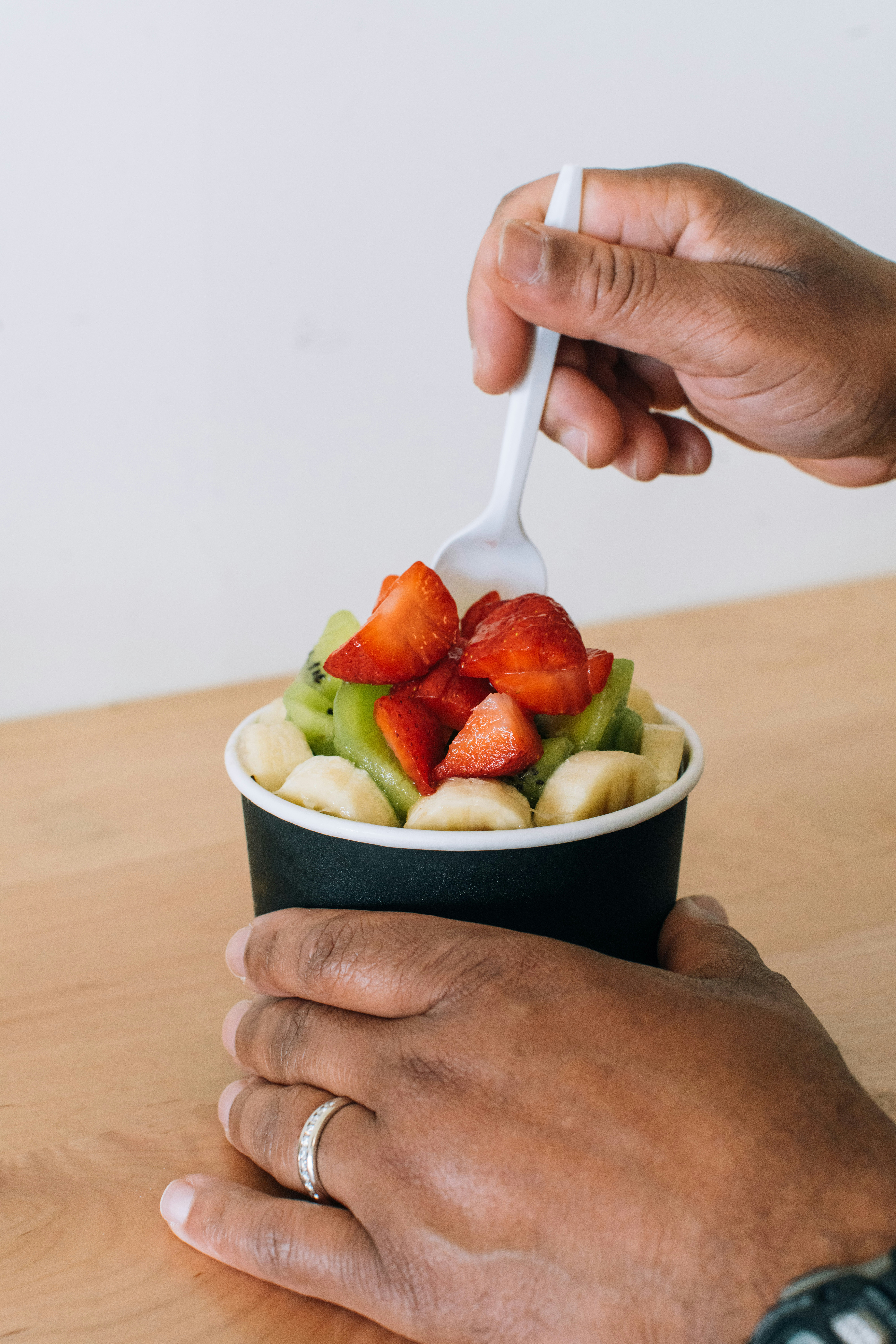 Eating a bowl of fresh fruit.