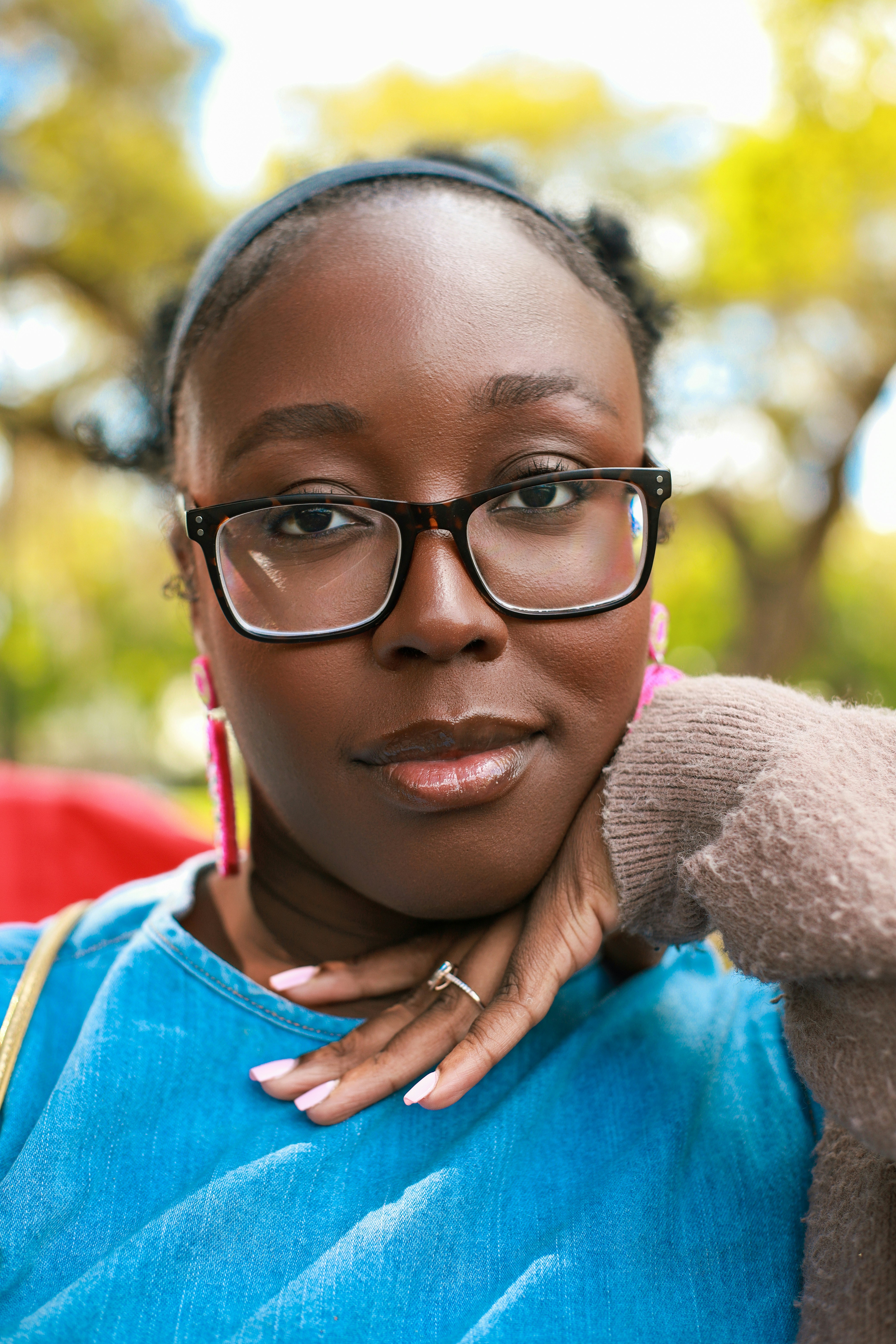 A woman poses, looking at the camera.