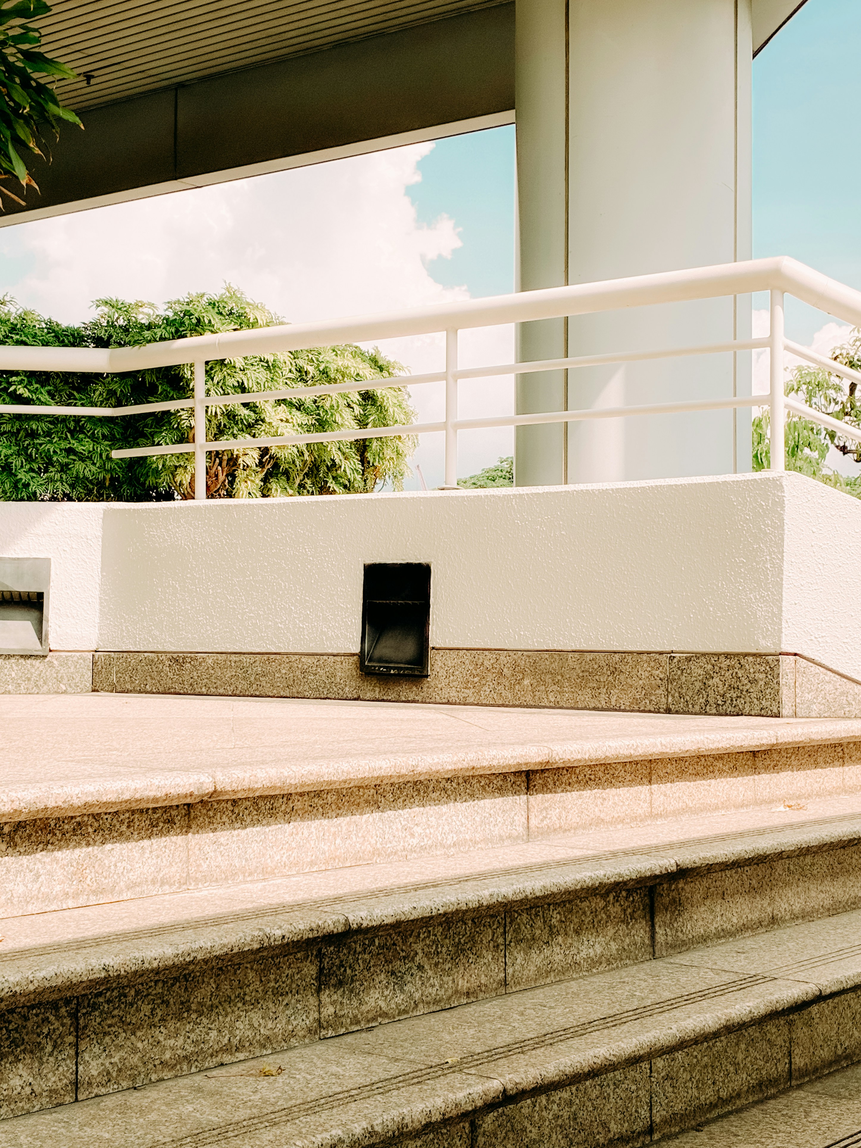 A balcony and stairs on a sunny day.