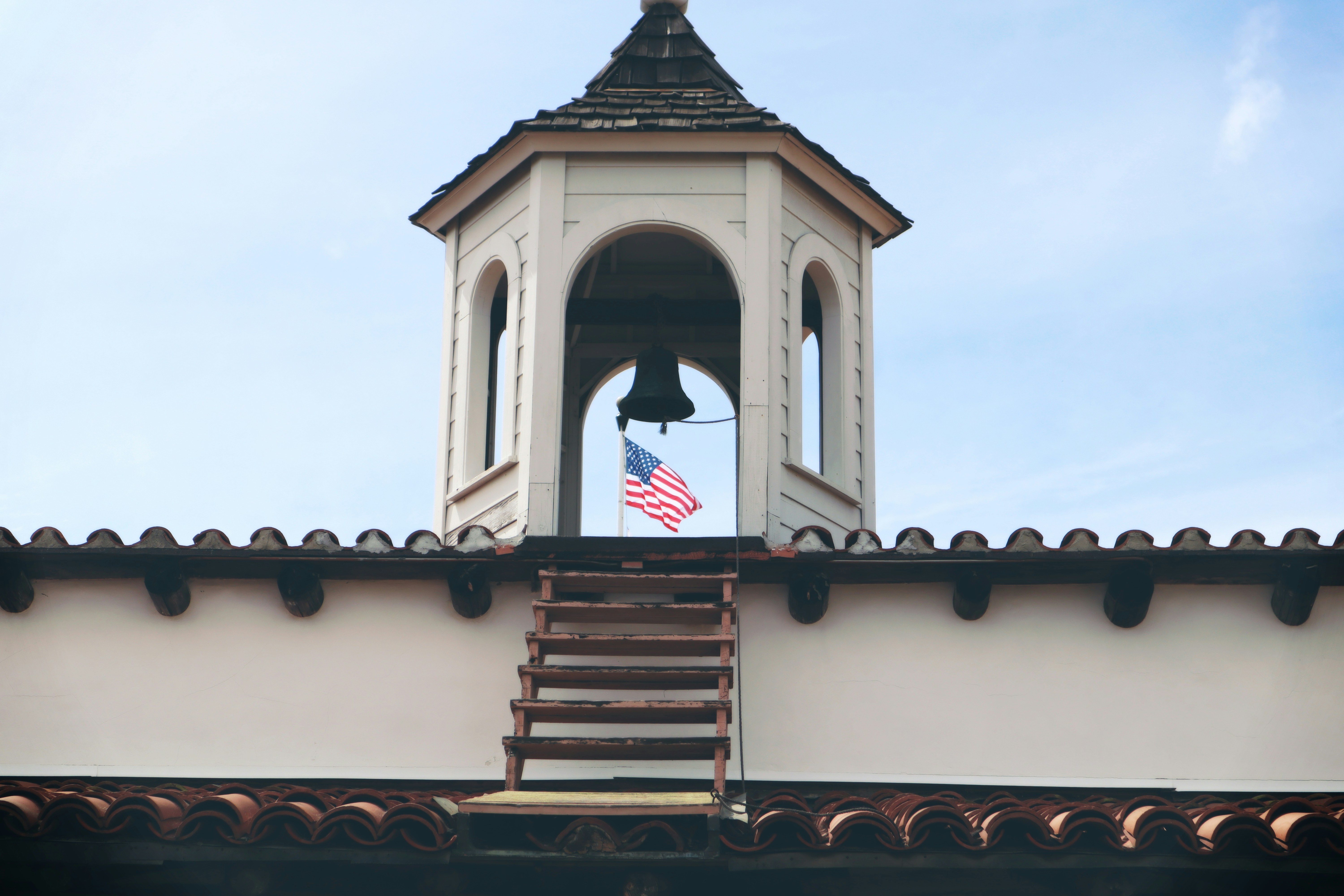 Bell tower displays the american flag.