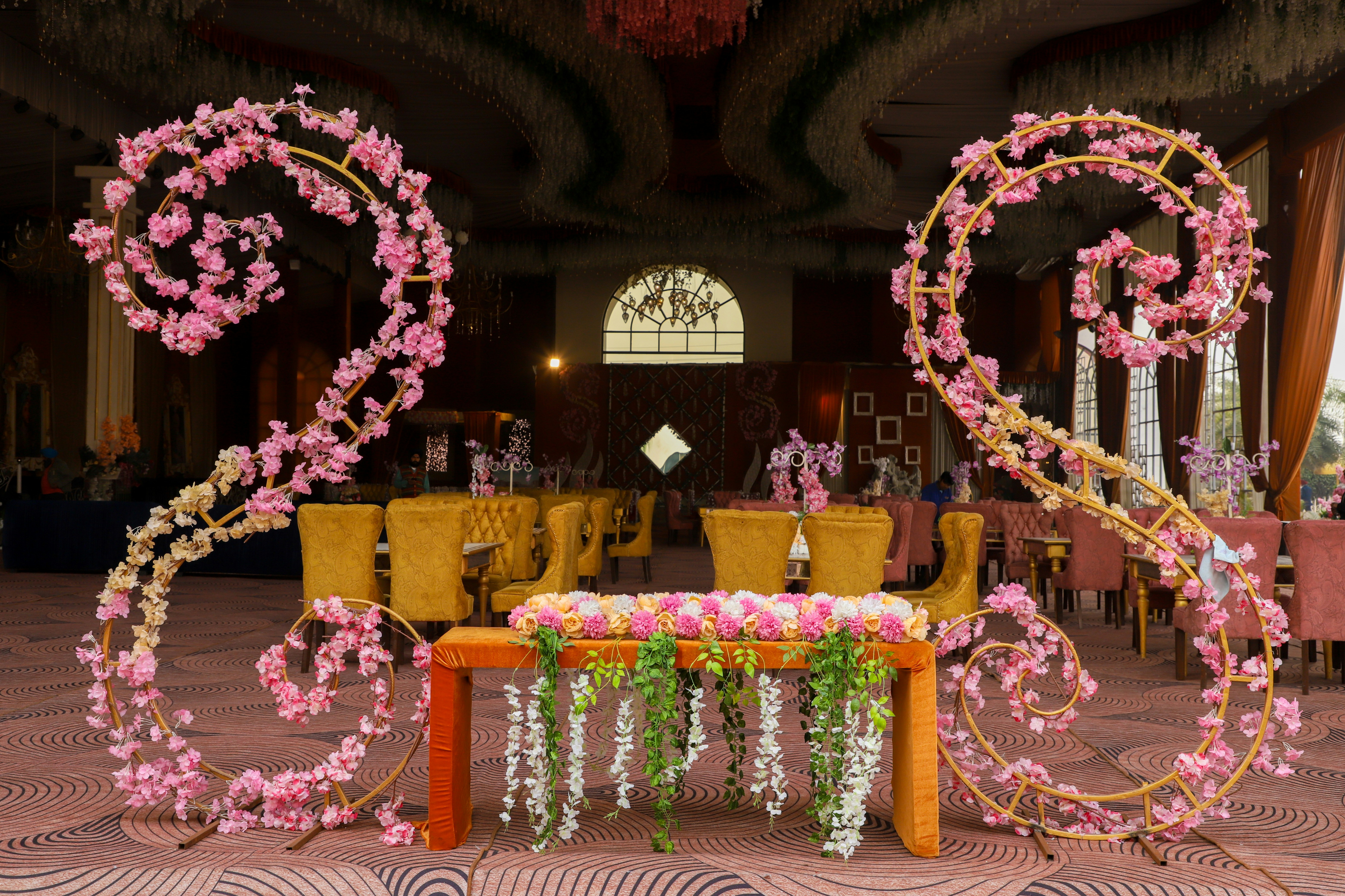 Wedding decorations feature floral arrangements and tables.