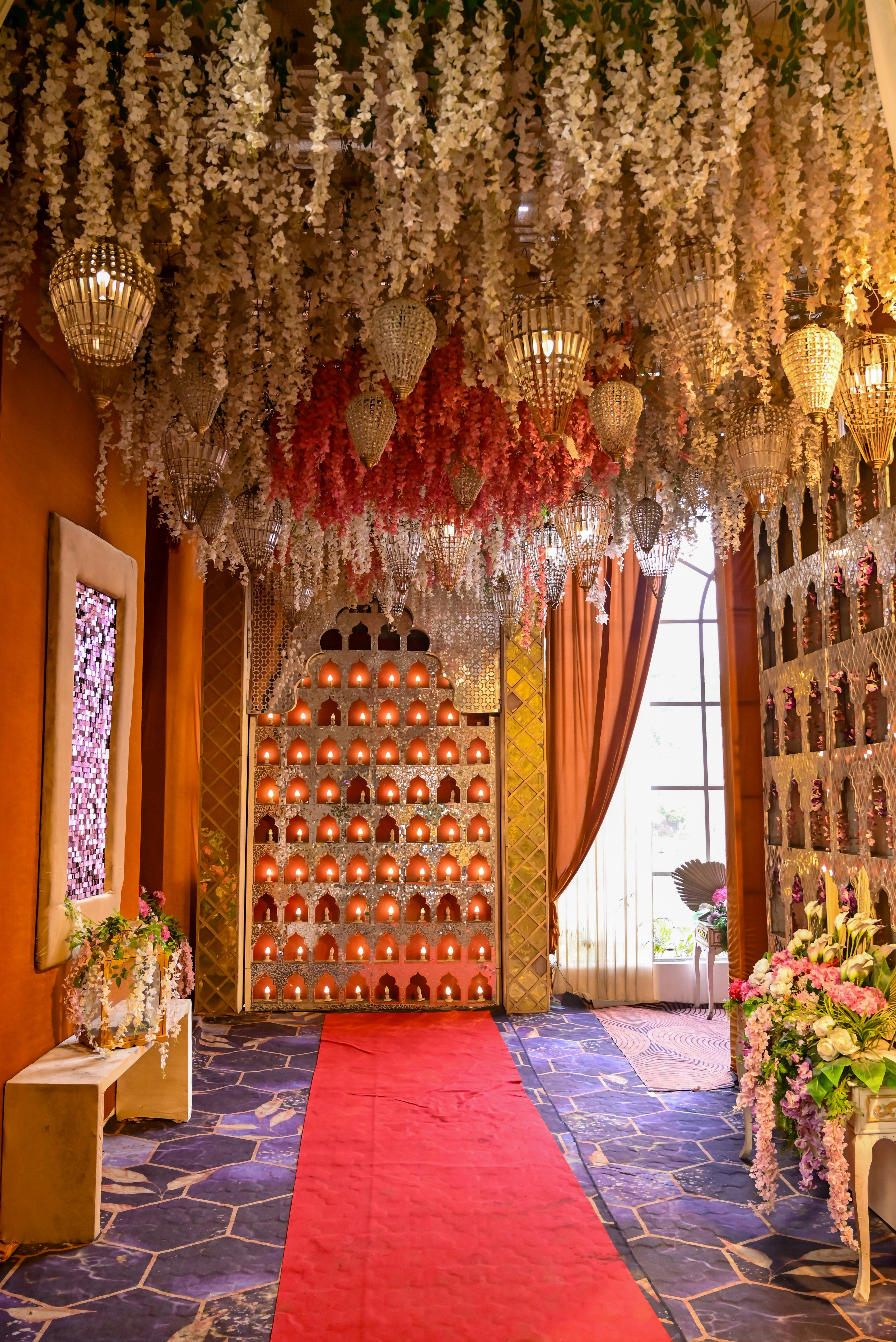 Elegant event hall decorated with lights and flowers.