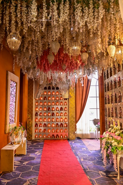 Elegant event hall decorated with lights and flowers.