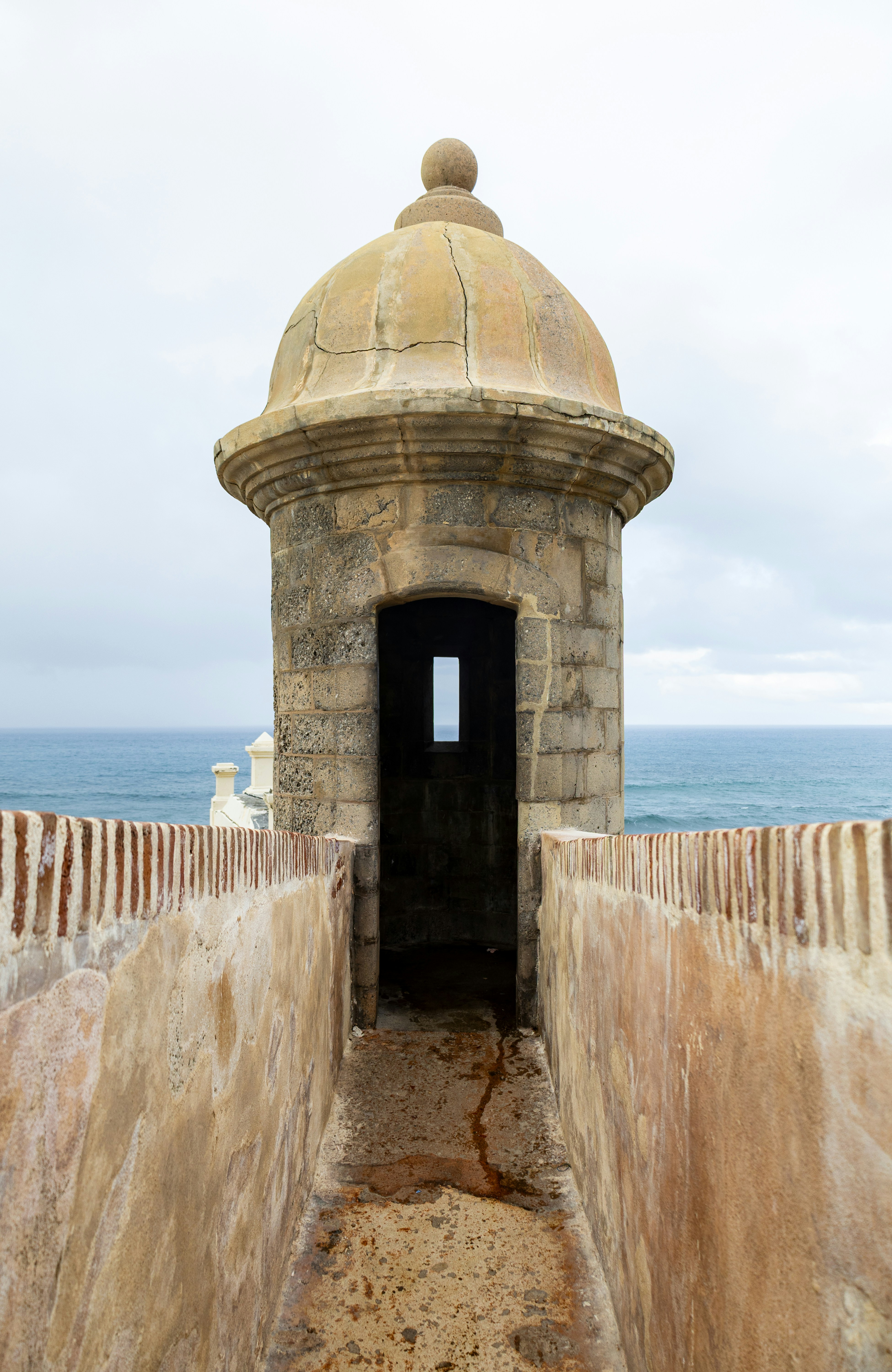 A stone sentry box overlooks the ocean.