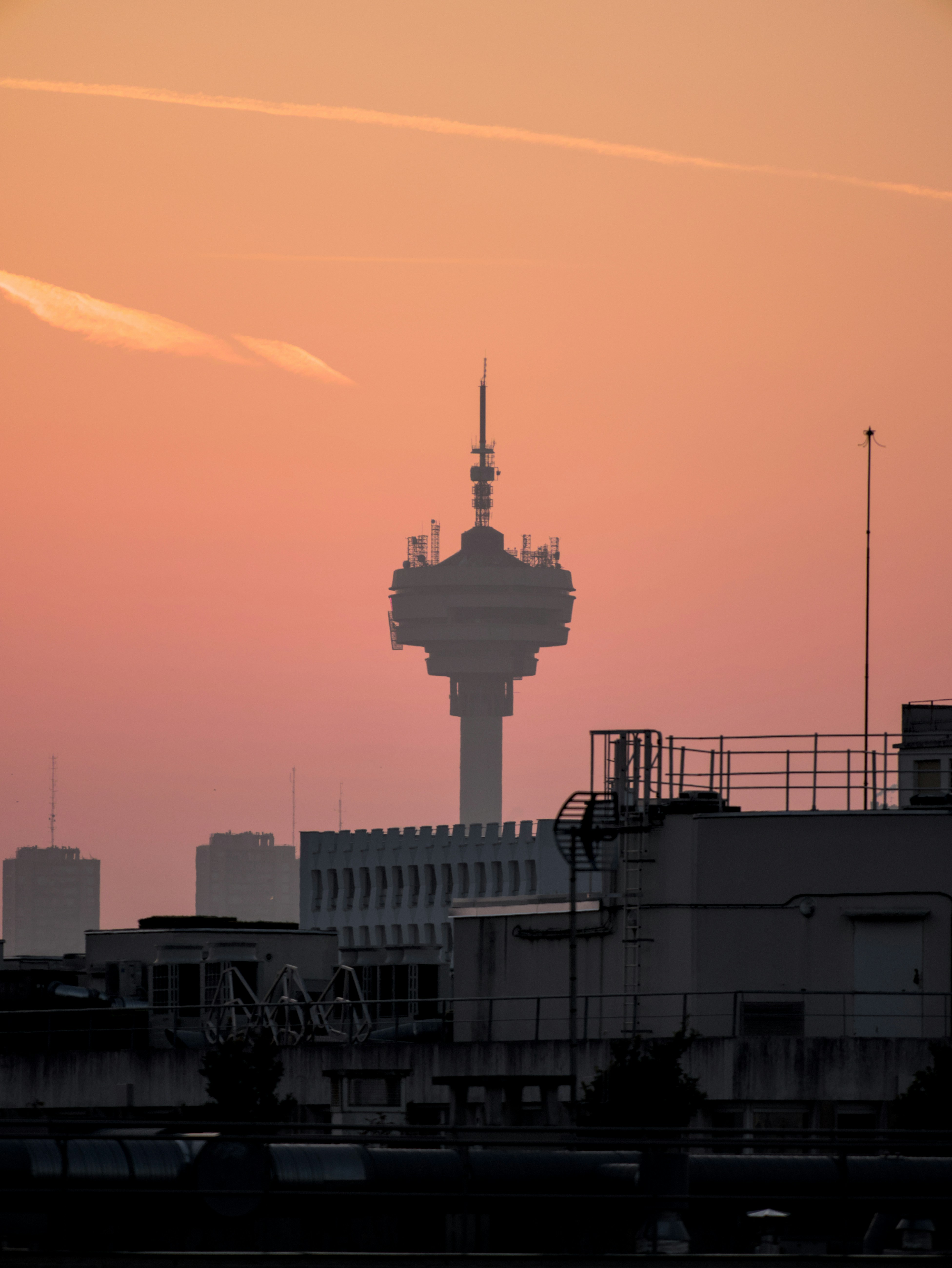 A TV tower silhouetted against a colorful sunset.