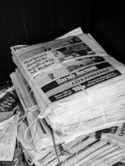 A stack of newspapers tied together with string.