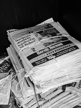 A stack of newspapers tied together with string.